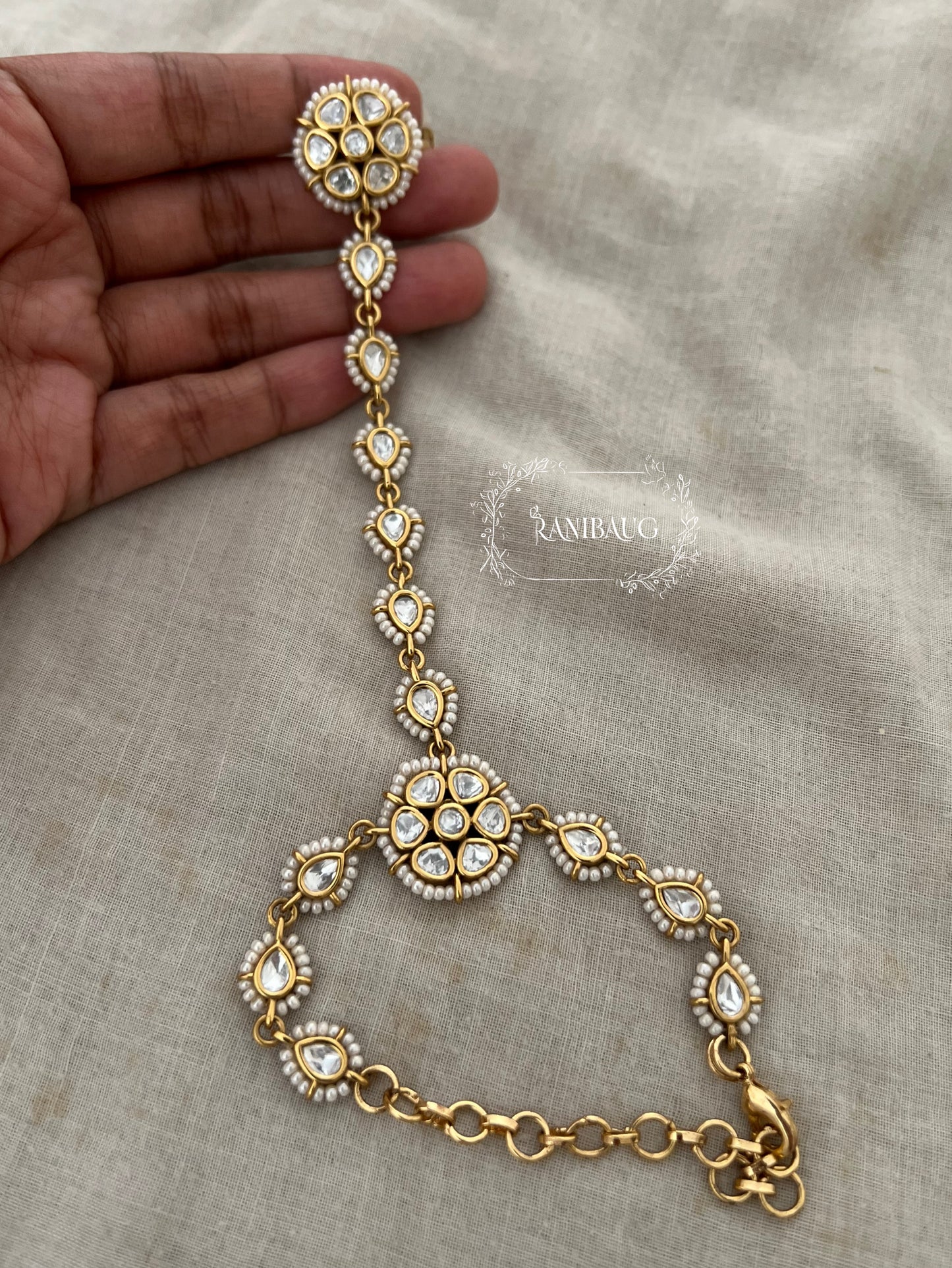 Amisha Floral Kundan Haath Phool Jewelry Outlined With Tiny Pearls And Rich Gold Finish By Ranibaug