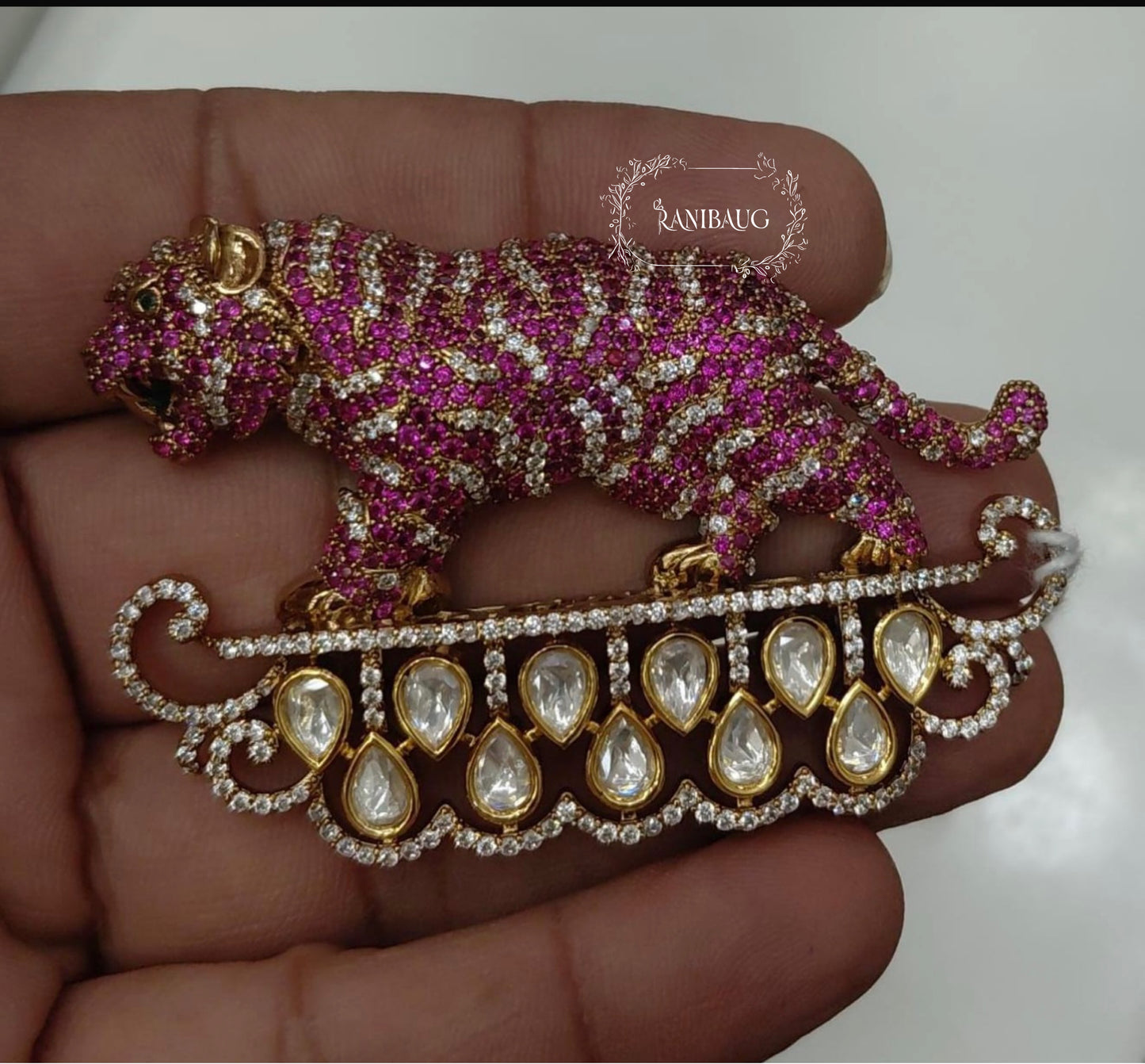a pink tiger brooch in gold plating and polki diamond studded