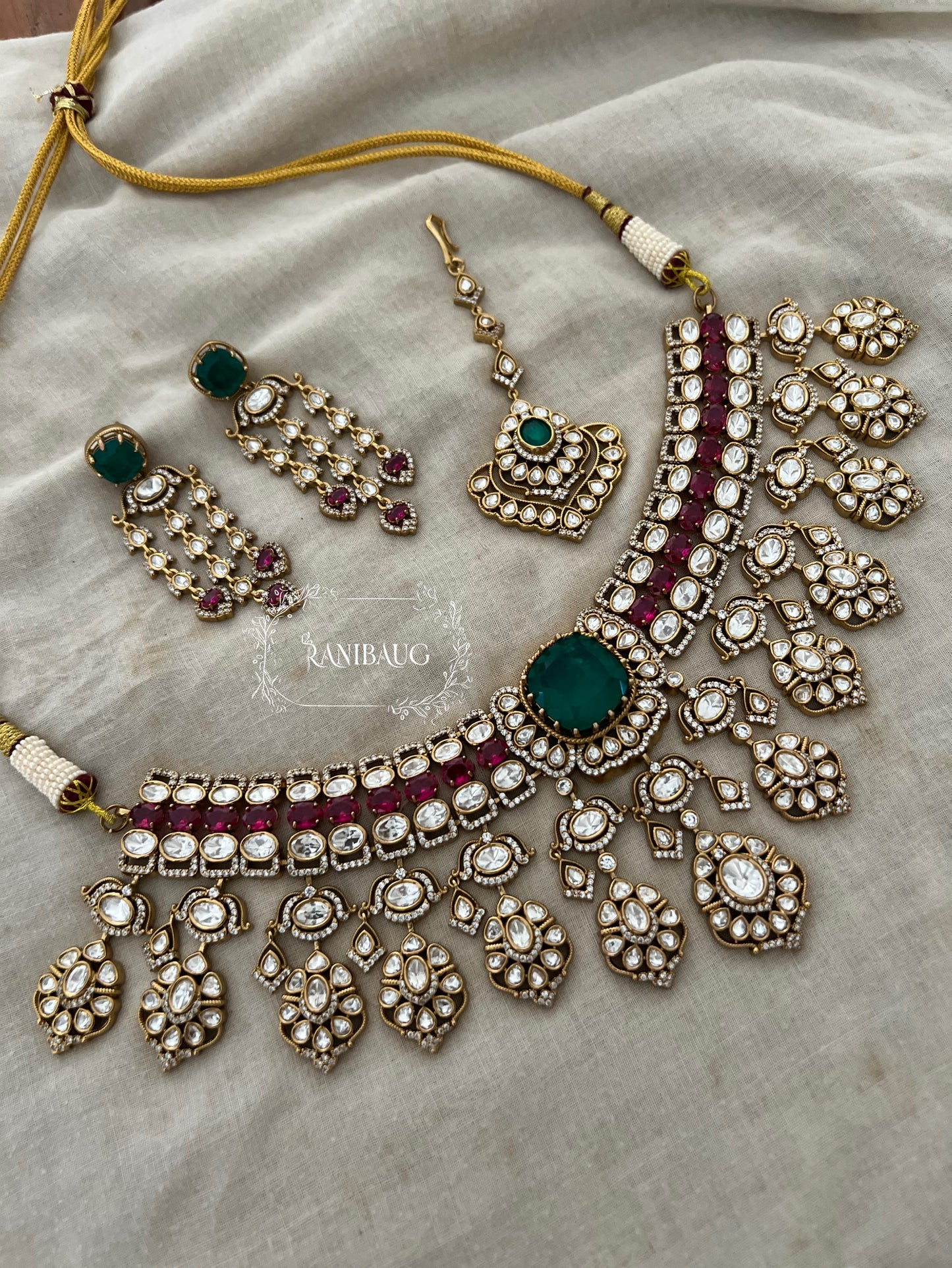 Nayera Mossainite Polki Victorian Gold Finish Necklace Jewelry Set With Maang Tikka And Emerald Ruby Stone Accents By Ranibaug