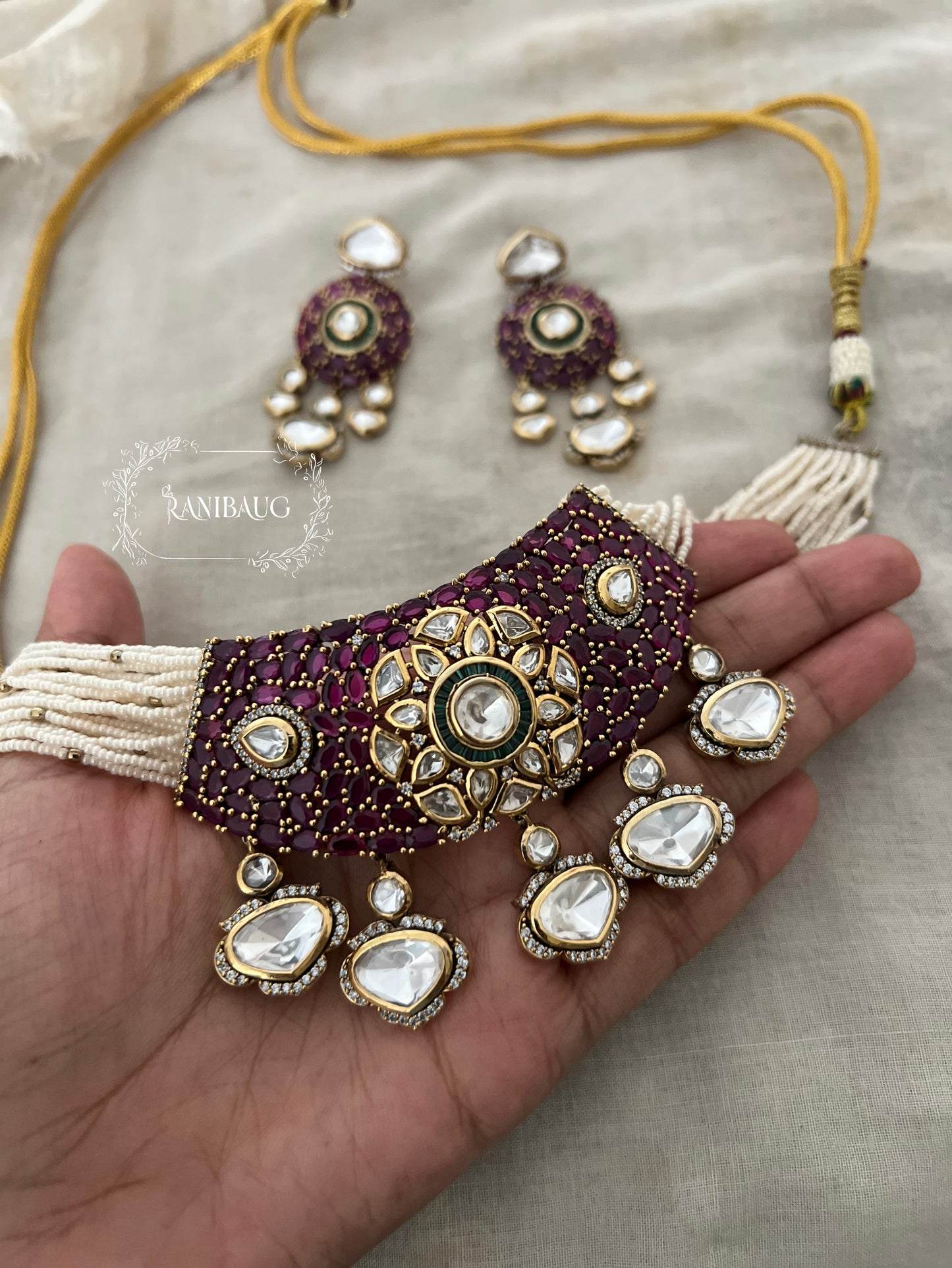 Riva Emerald Stone Polki Floral Motif Kundan Drop Gold Plated Pearl Strand Choker Necklace Set By Ranibaug