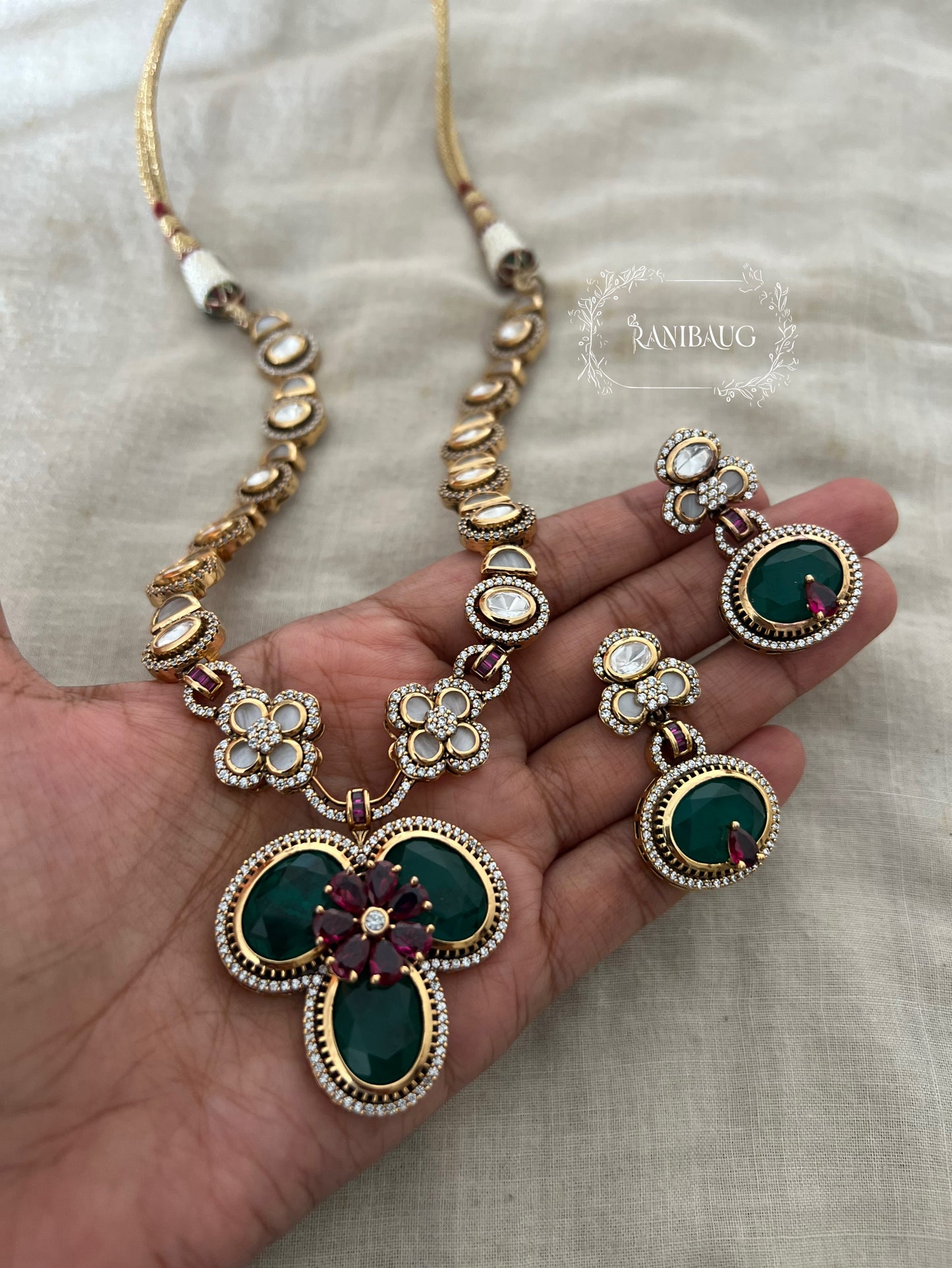 Verya Clover Leaf Inspired Emerald Ruby And Polki Adorned In Premium Gold Finish Designer Jewellery Set By Ranibaug
