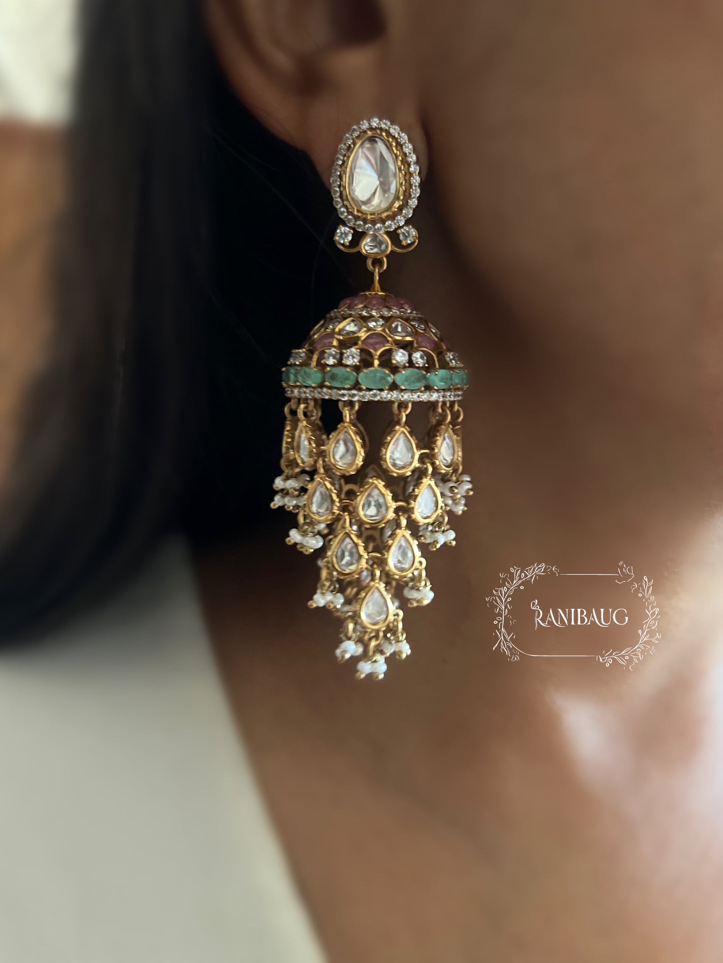 Aaravi Polki Fall Premium Gold Finish Emerald Stones And Pearl Adorned Jhumka Earrings By Ranibaug