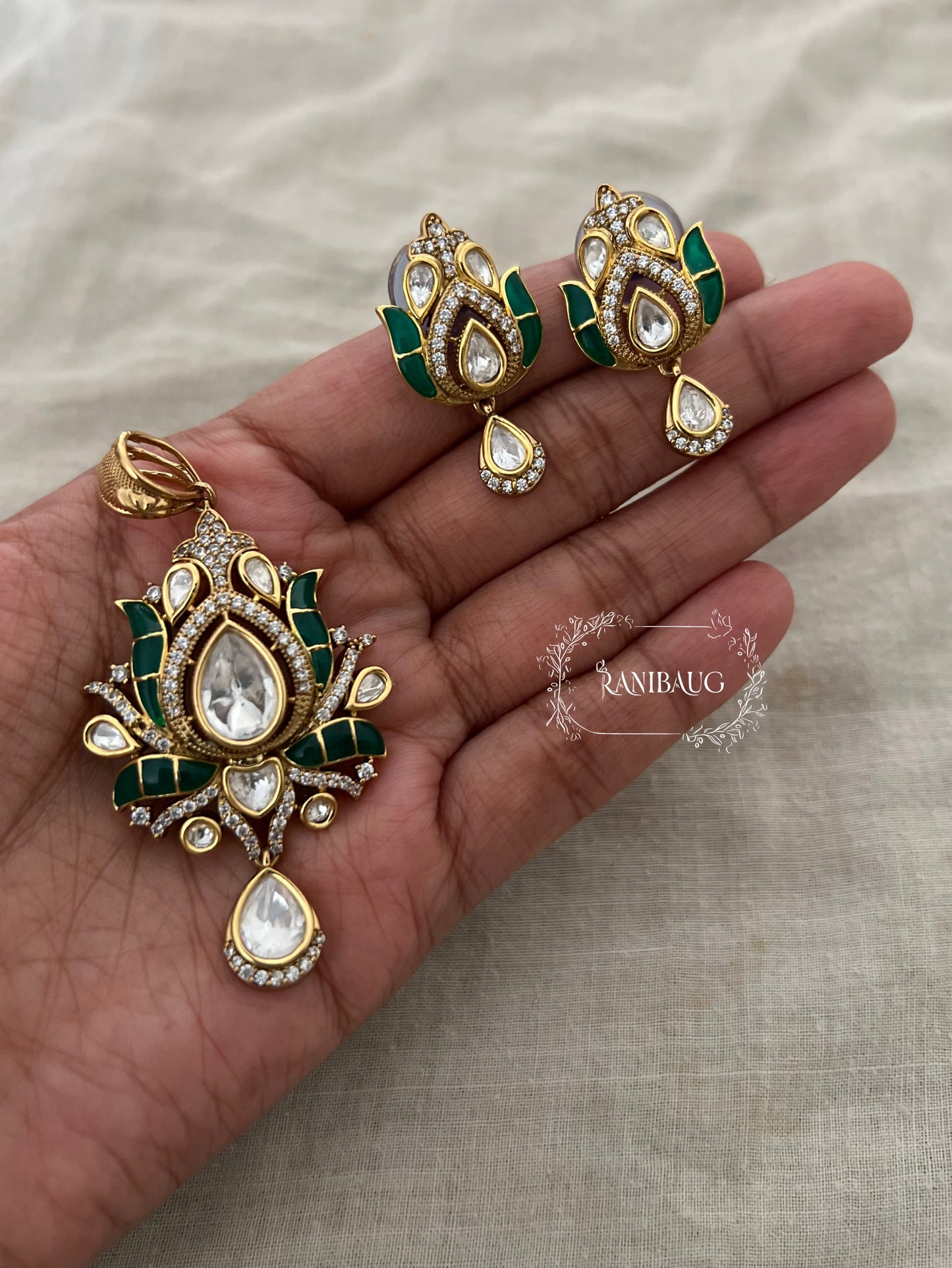 Aarya Polki Drop Tulip Floral Motif In Rich Gold Finish And Emerald Green Enamel Work By Ranibaug