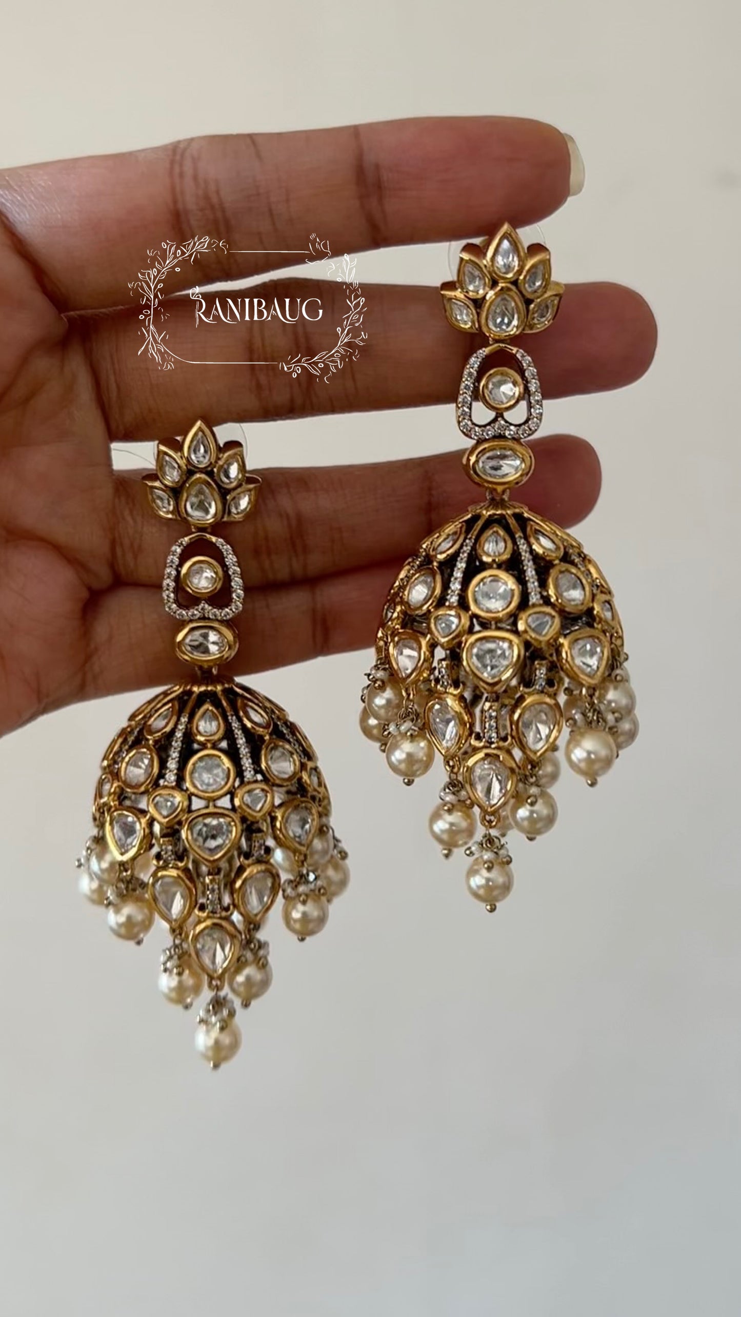 Alaana Regal Kundan-Polki Jhumka Earrings with Pearl Clusters in Antique Gold Finish by Ranibaug | Trendiest Wedding Earring Collection in India 2026