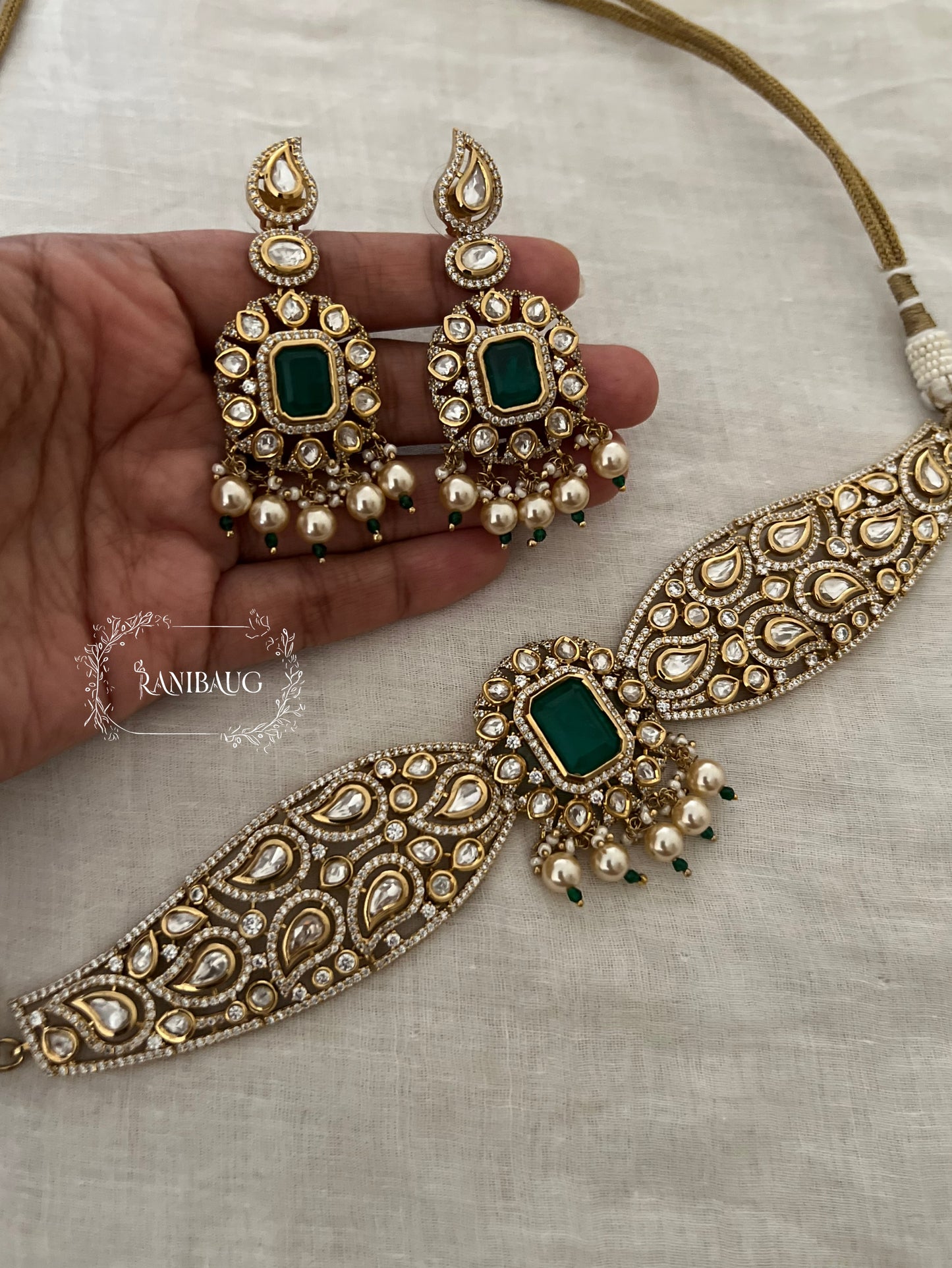 Ashika Emerald Teardrop Polki Motif And Pearl Adorned Royal Neck Choker Jewellery Set By Ranibaug | The Royal Wedding Collection 2026