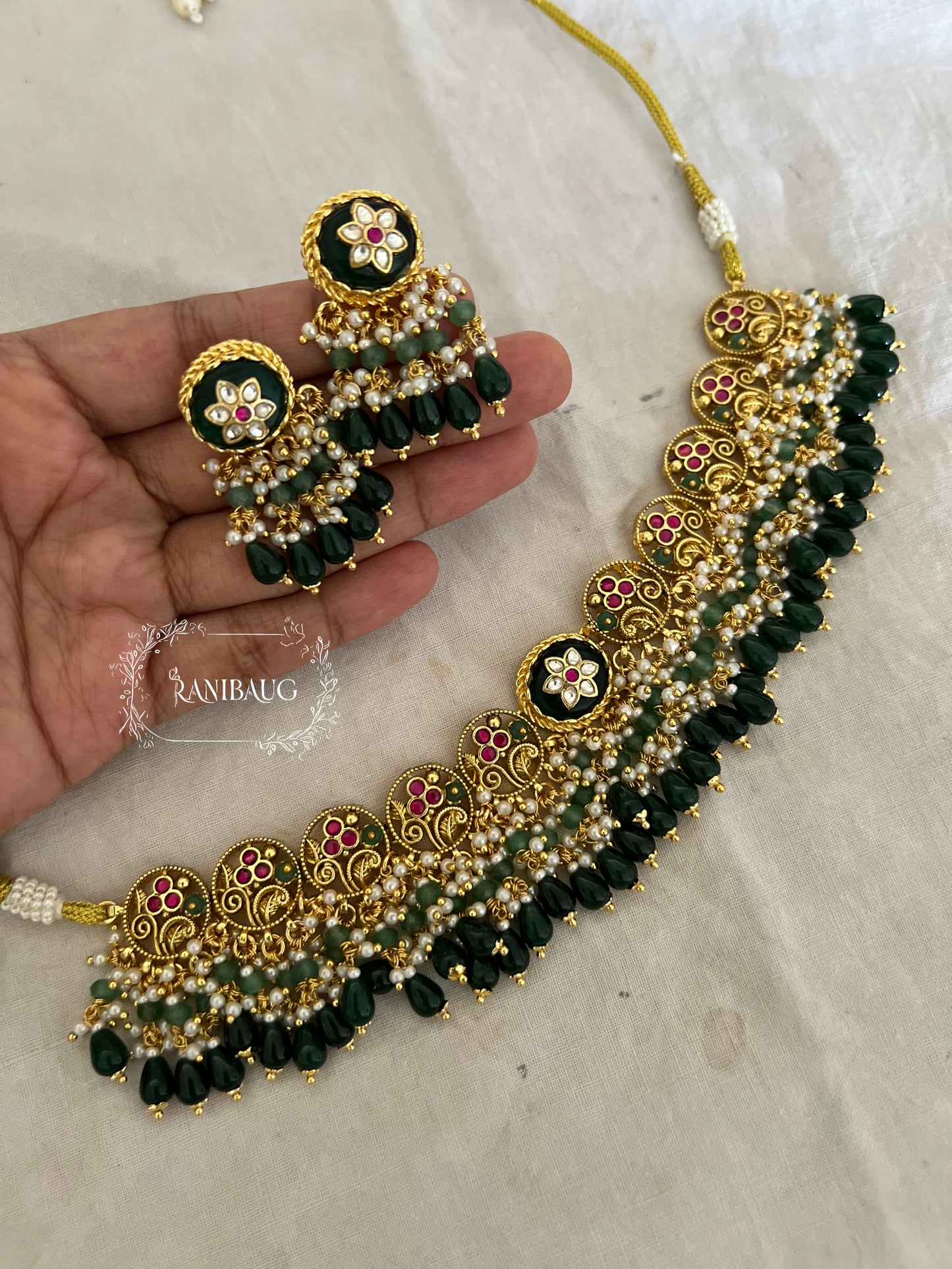 Chavvi Deep Emerald Green Floral Motif Beaded And Pearl Adorned Premium Gold Finish Unique Designer Heritage Set By Ranibaug