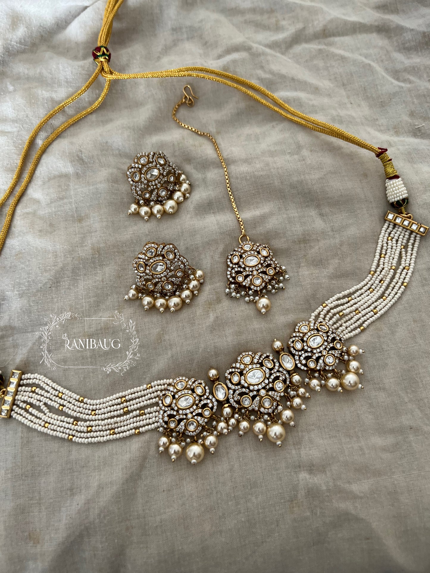 Hema Pearl Polki Zirconnia Pearl Adorned Beaded Multi Strand Royal Choker Necklace Set With Maang Tikka By Ranibaug