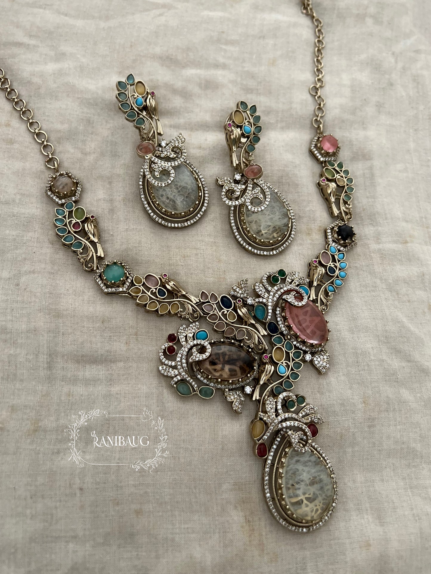 Sabya Multicolor Gemstone Kundan And Pearl Tejasvi Choker Jewellery Set In Antique Gold Finish By Ranibaug