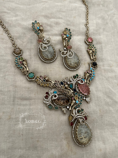 Sabya Multicolor Gemstone Kundan And Pearl Tejasvi Choker Jewellery Set In Antique Gold Finish By Ranibaug