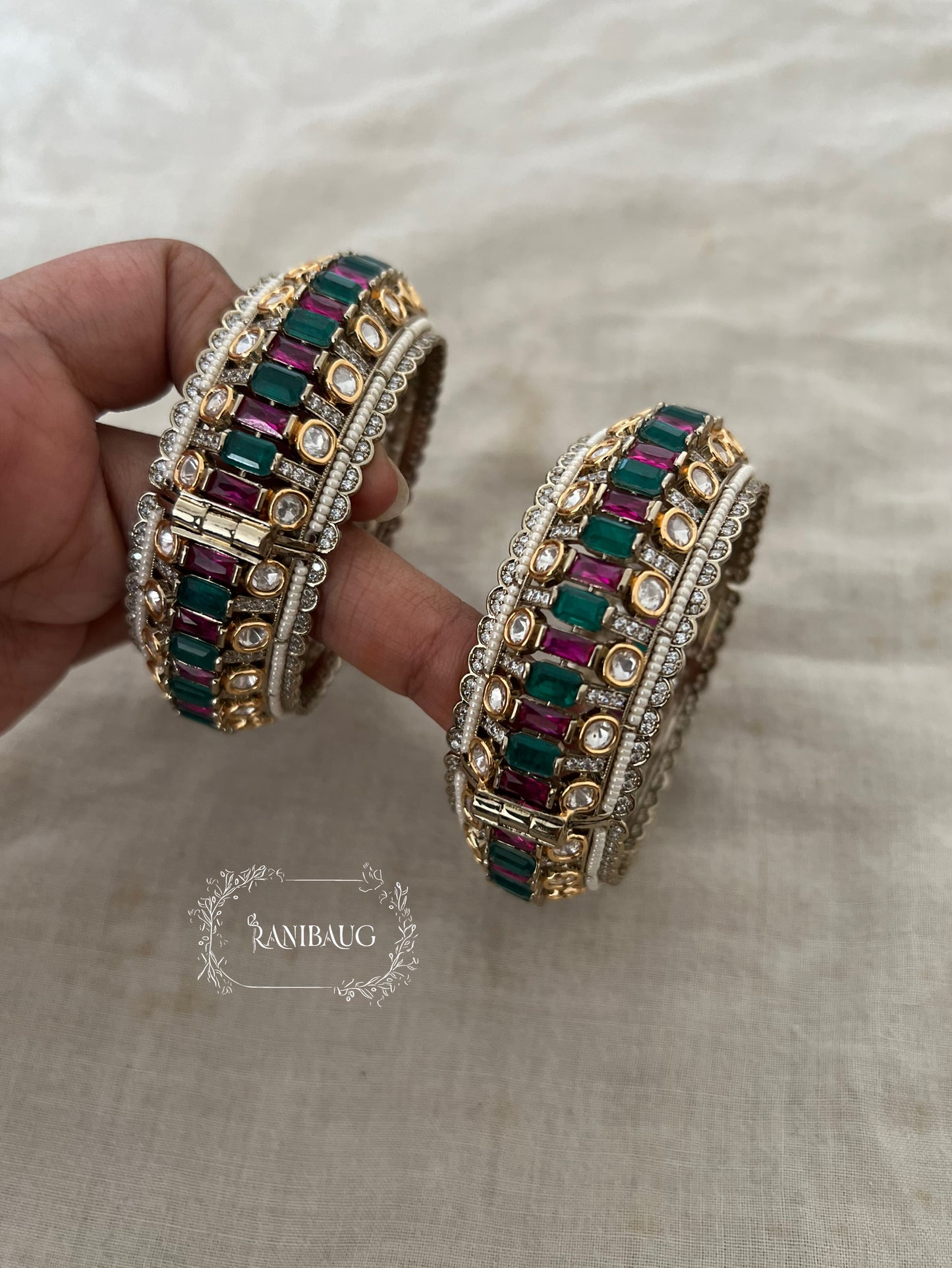 Kairavi Emerald Ruby Stones Polki Studded Gold Finish Pearl Adorned Broad Statement Kada Bangles By Ranibaug