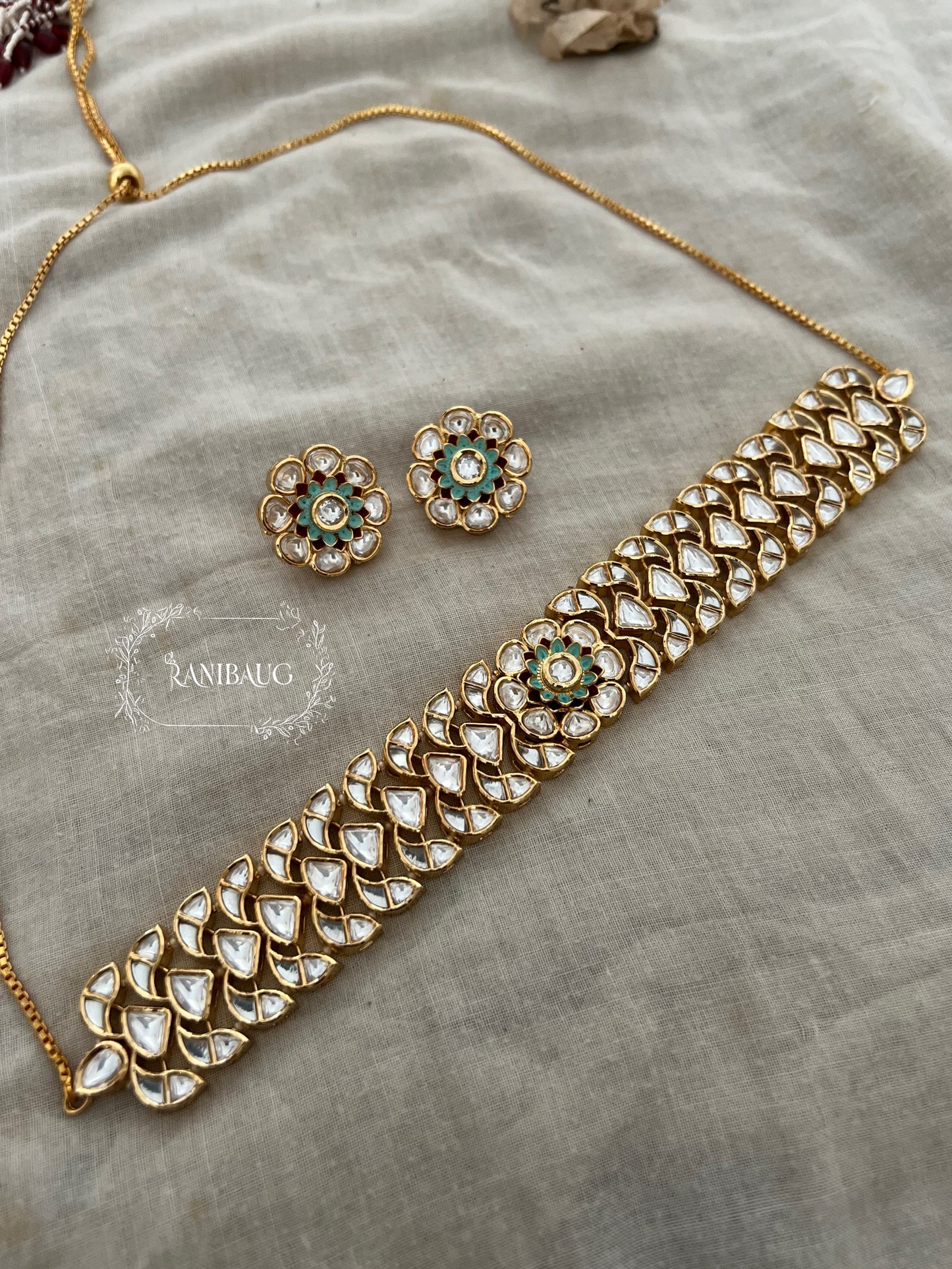 Kanika Flower Design Featuring In Premium Mossainite Kundan And Rich Gold Finish Choker Necklace Set With Flower Stud Earrings By Ranibaug