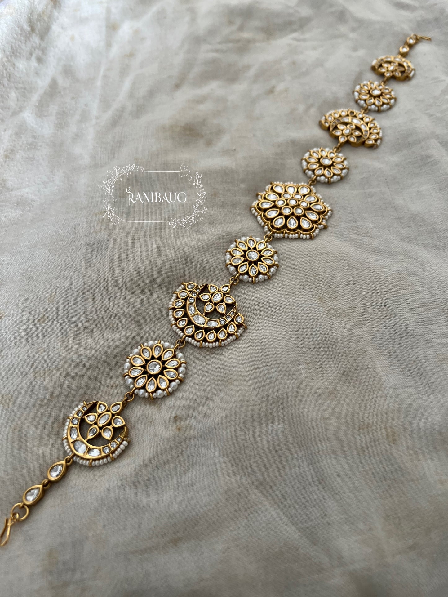 Mallika Floral And Crescent Kundan Motif Sheesh Patti Hair Jewellery In Rich Gold Finish And Premium Pearl Outlining By Ranibaug