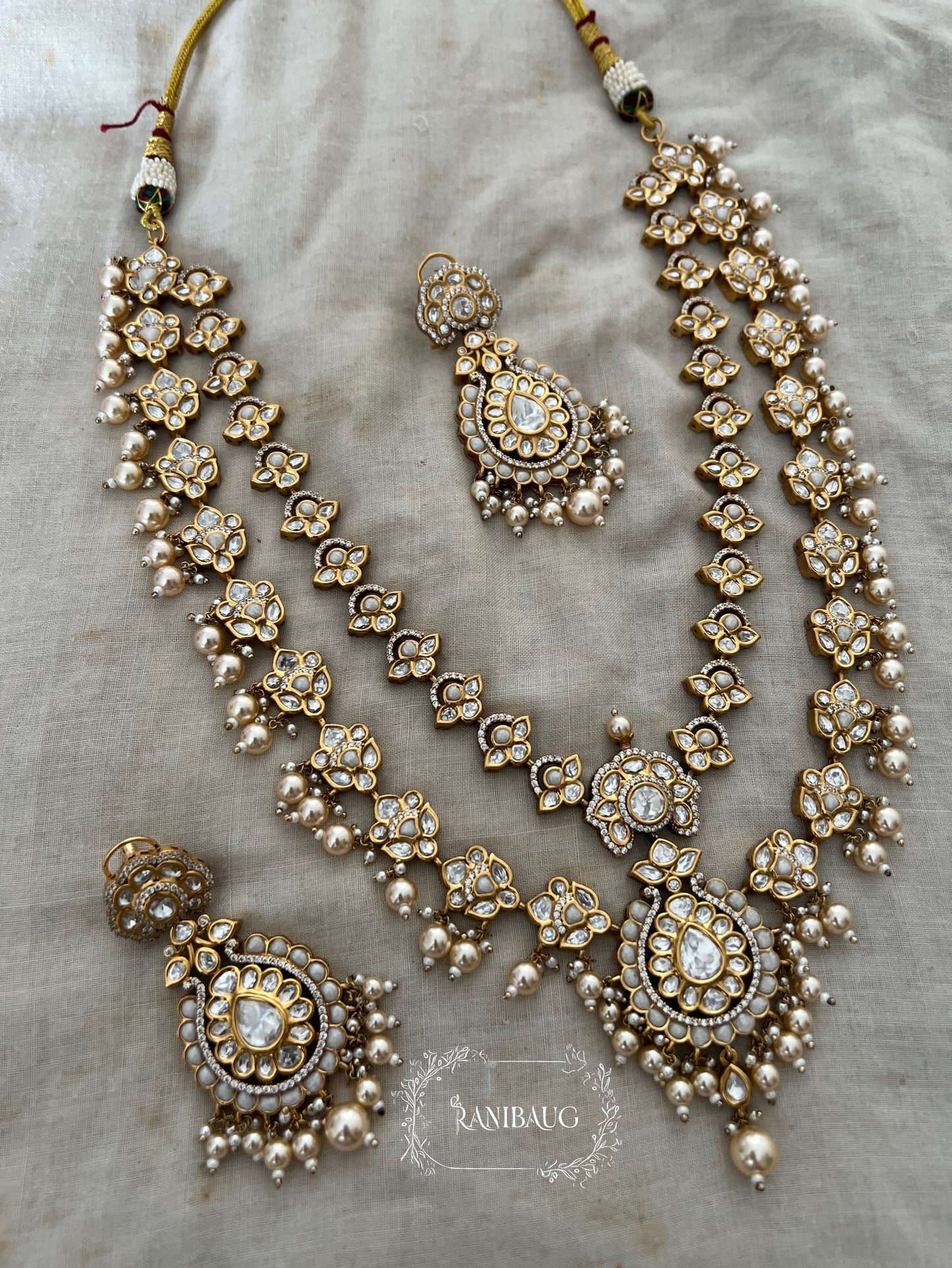 Mayera Layered Gold Plated Traditional Style Wedding Necklace Jewellery Set With Earrings And Maang Tikka By Ranibaug