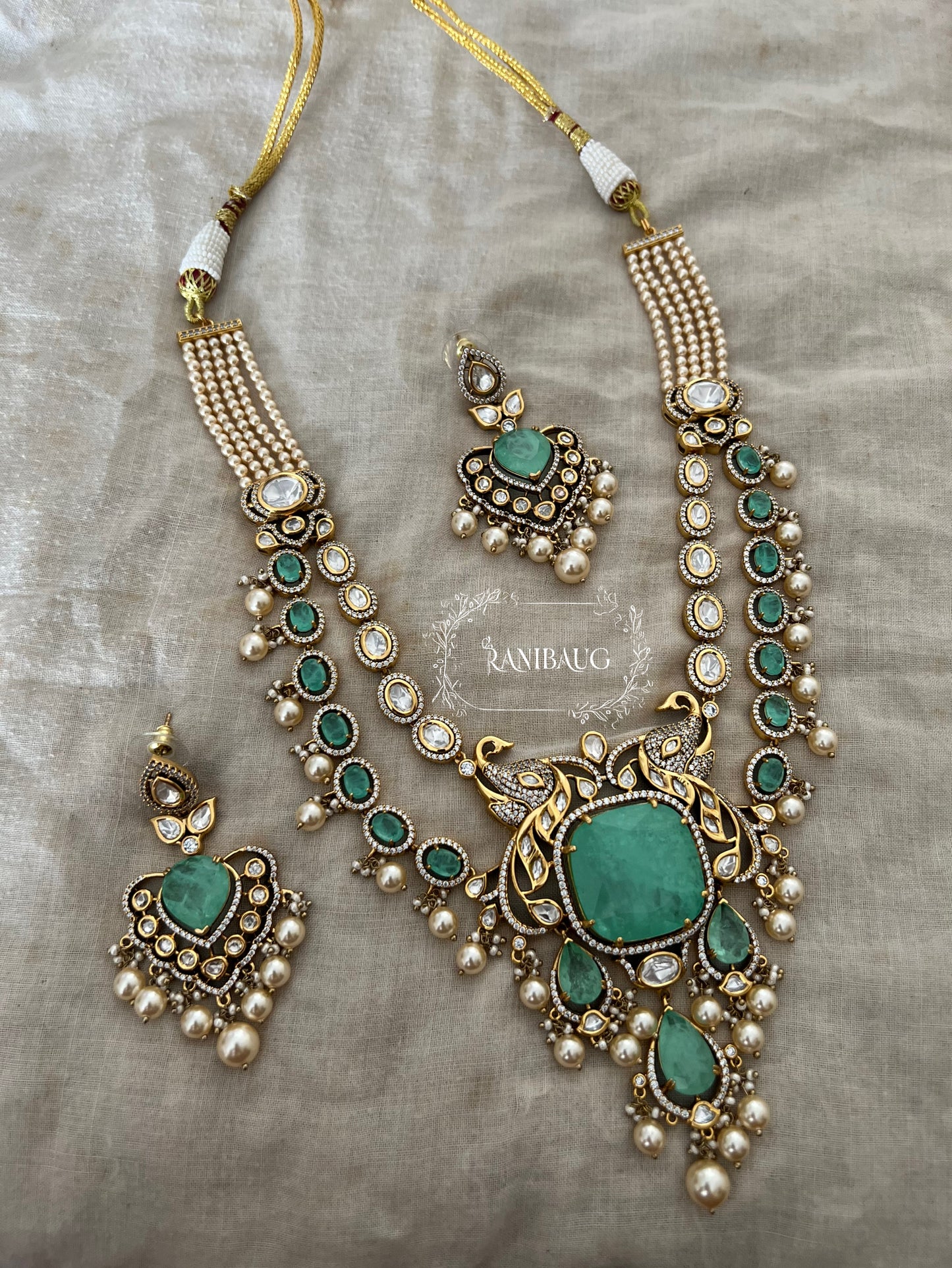 Mayuri Gold Finish Peacock Motif Polki Studded Layered Mint Stone Motif Necklace Jewellery Set With Dangling Pearls By Ranibaug