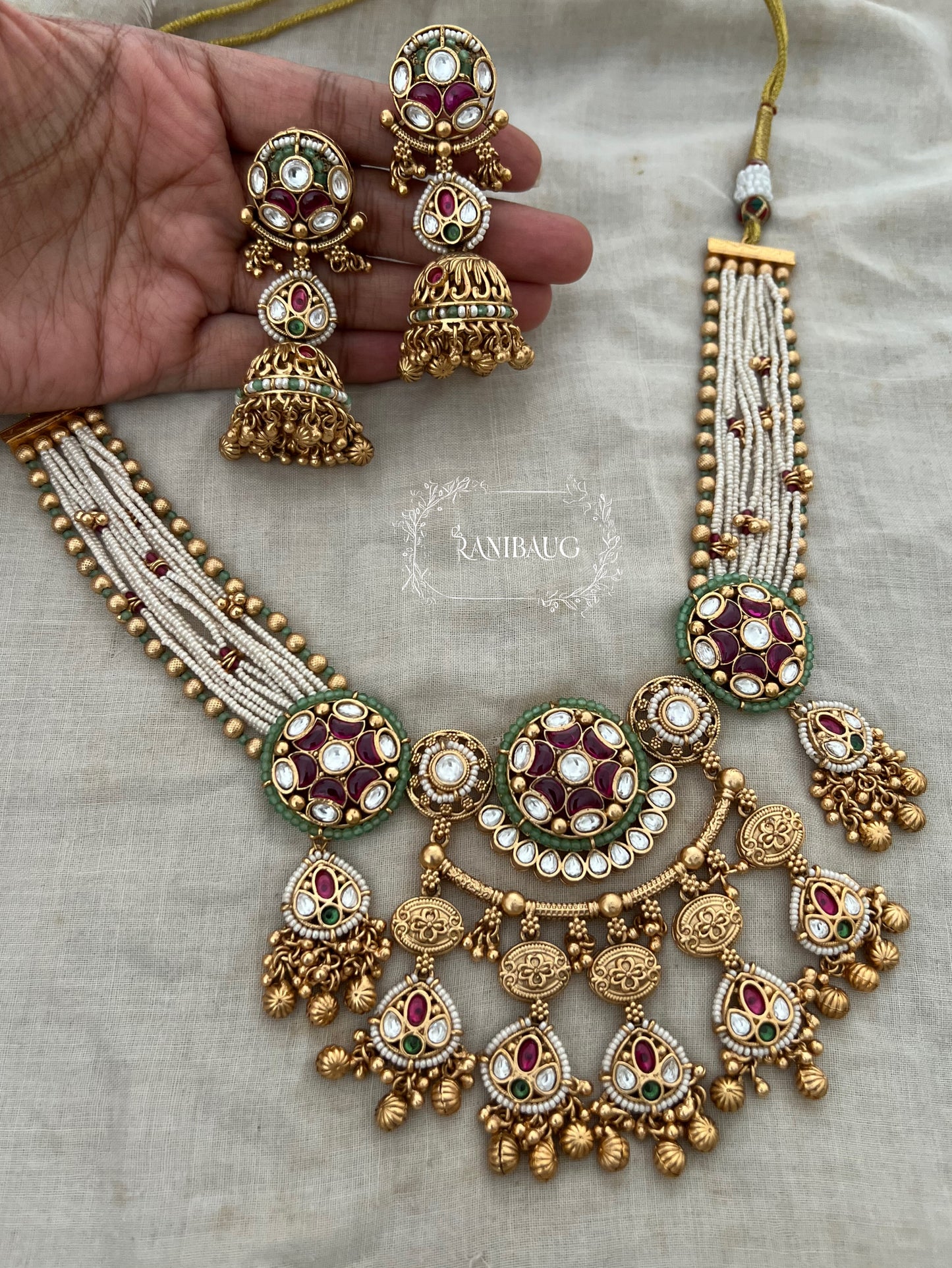 Mehrang Royal Designer Kundan Studded Pearl Beaded Gold Finish Emerald Ruby Adorned Necklace Set By Ranibaug
