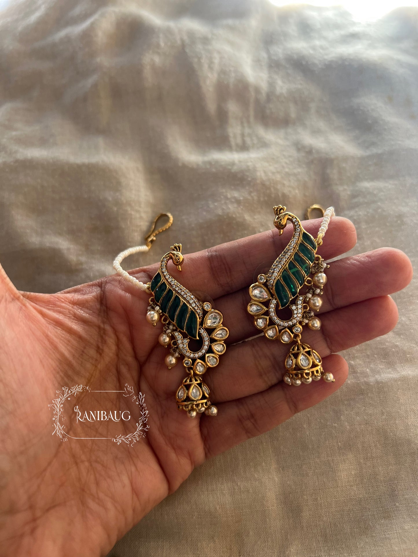 Natasha Statement Peacock Motif Gold Plated Polki Studded Earcuff Jhumki With Mini Pearl Hair Chain By Ranibaug | Designer Latest Festive Earrings Collection 2026