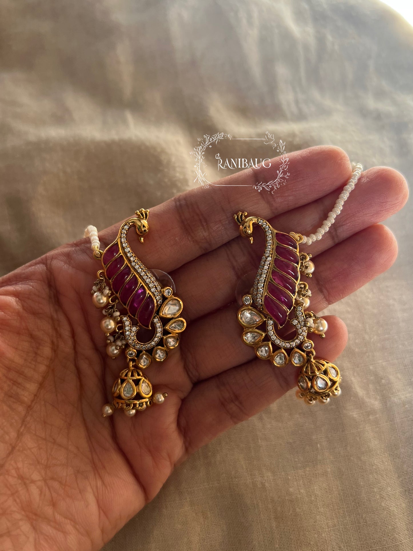 Natasha Statement Peacock Motif Gold Plated Polki Studded Earcuff Jhumki With Mini Pearl Hair Chain By Ranibaug | Designer Latest Festive Earrings Collection 2026