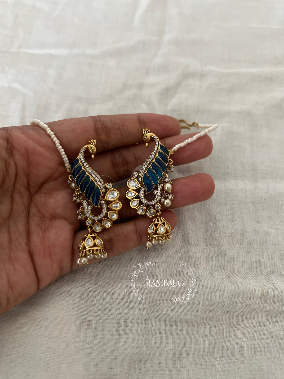 Natasha Statement Peacock Motif Gold Plated Polki Studded Earcuff Jhumki With Mini Pearl Hair Chain By Ranibaug | Designer Latest Festive Earrings Collection 2026
