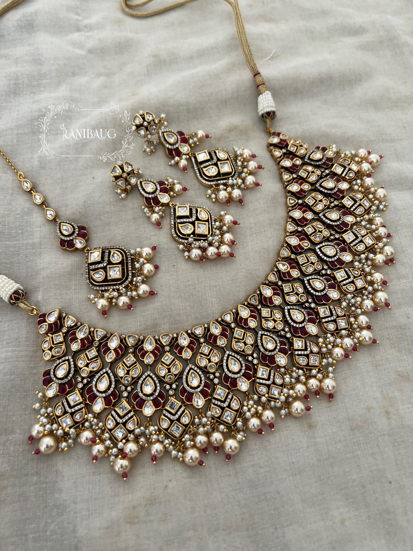 Navya Creamy Pearls Rich Gold Finish Polki Kundan Stuuded Bridal Necklace Jewellery Set With Maang Tikka By Ranibaug