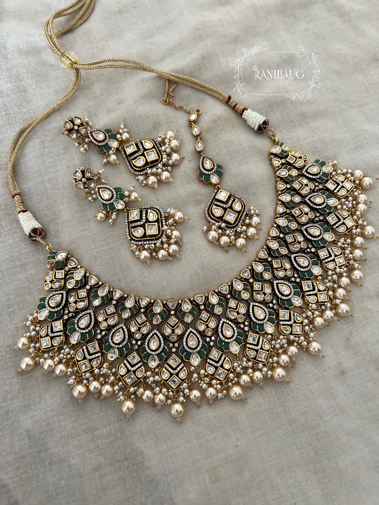 Navya Creamy Pearls Rich Gold Finish Polki Kundan Stuuded Bridal Necklace Jewellery Set With Maang Tikka By Ranibaug