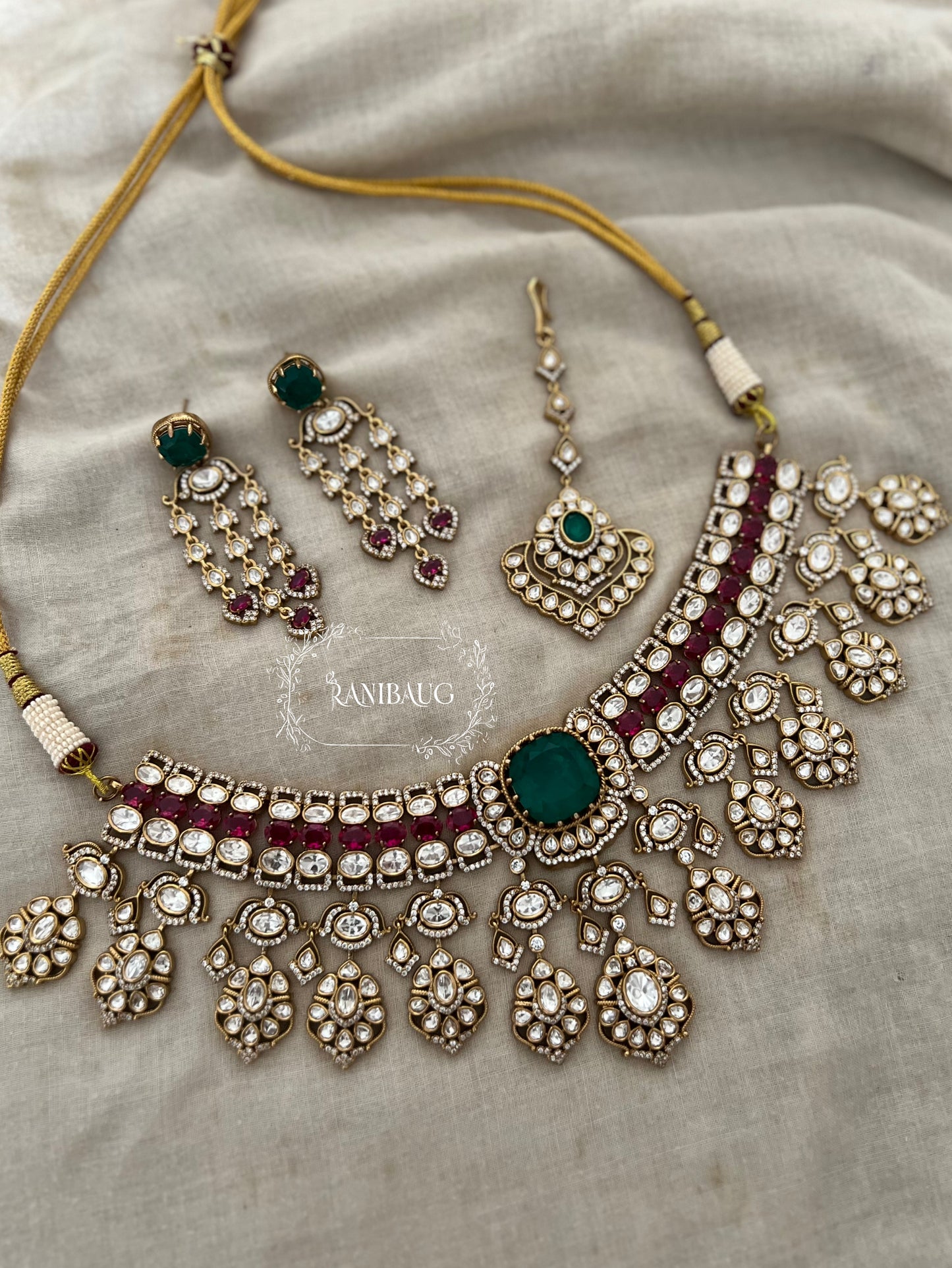 Nayera Mossainite Polki Victorian Gold Finish Necklace Jewelry Set With Maang Tikka And Emerald Ruby Stone Accents By Ranibaug