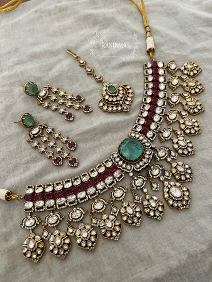 Nayera Mossainite Polki Victorian Gold Finish Necklace Jewelry Set With Maang Tikka And Emerald Ruby Stone Accents By Ranibaug
