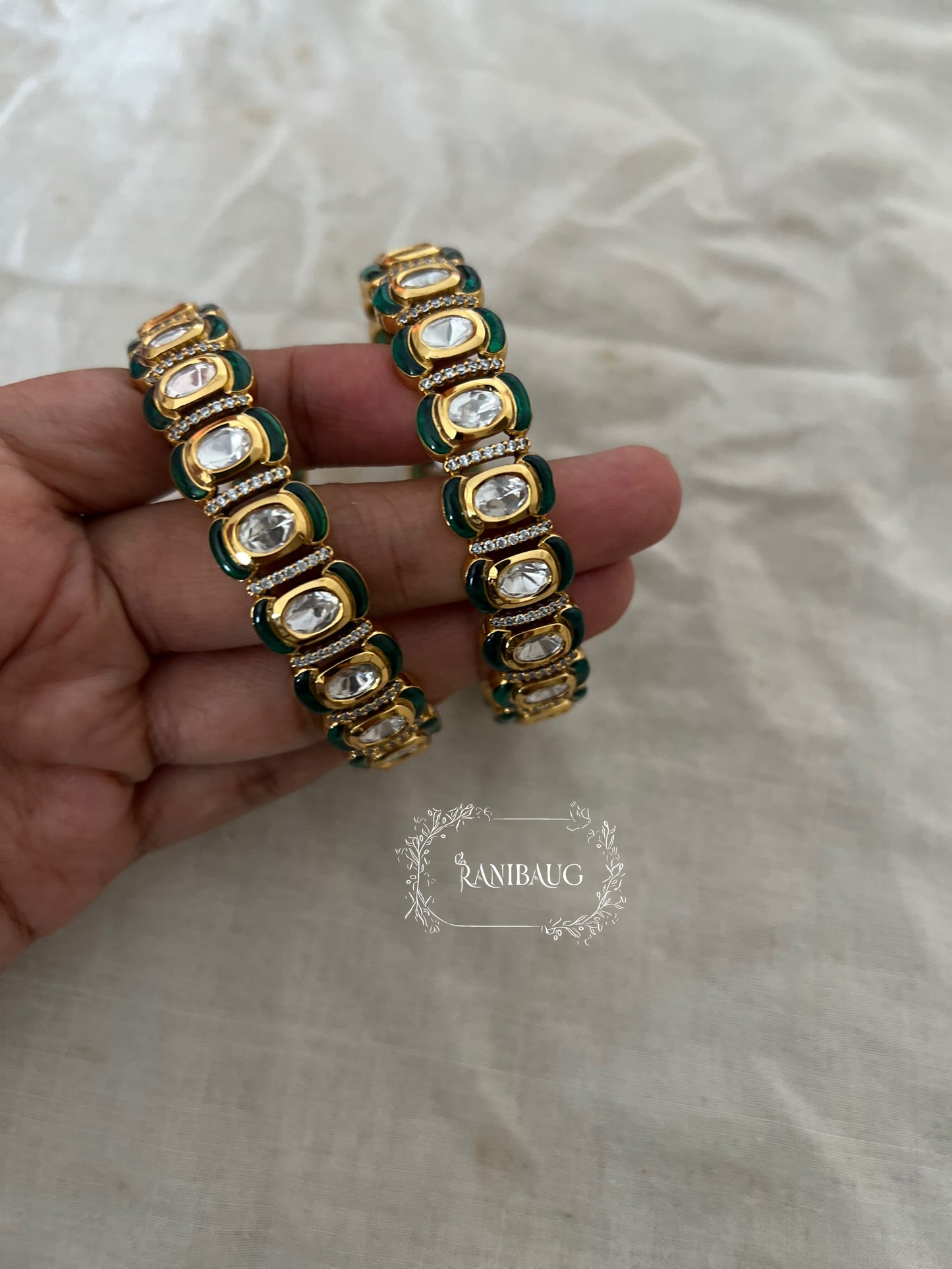 Niharini Gold Finish Oval Polki Kundan Motif Emerald Green Detailing Festive Bangles By Ranibaug