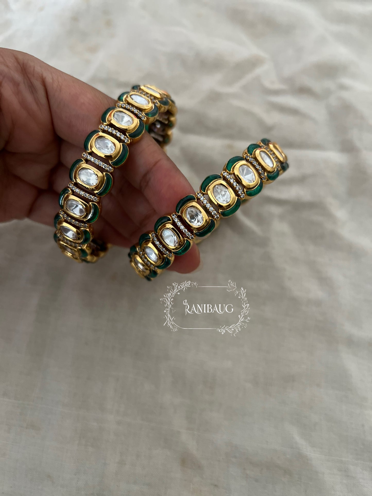 Niharini Gold Finish Oval Polki Kundan Motif Emerald Green Detailing Festive Bangles By Ranibaug