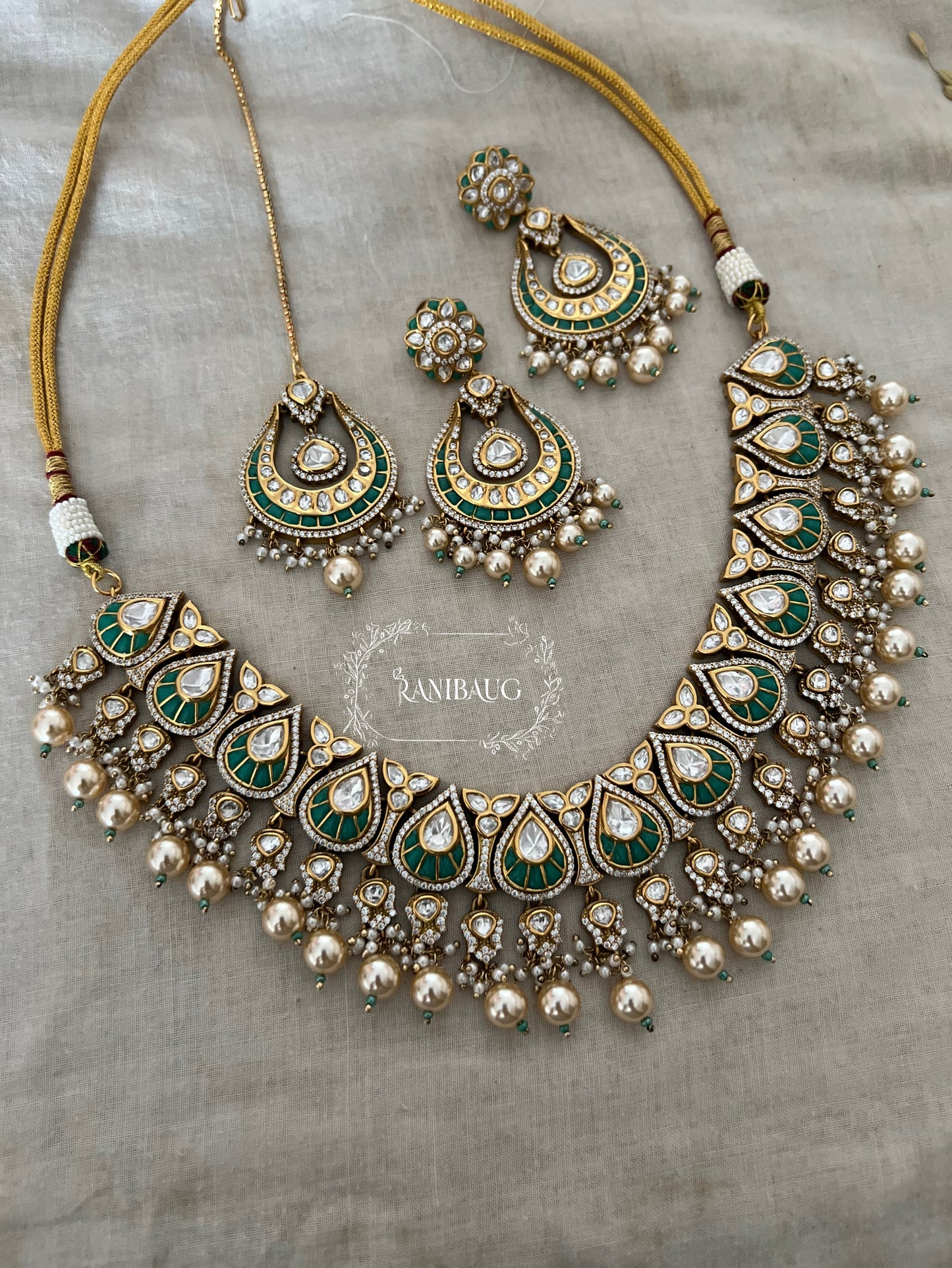 Nita Polki Kundan Necklace Set In Teardrop Enamel Motifs And Shiny Pearl Fringes In Premium Gold Finish With Contrasting Maangtikka By Ranibaug