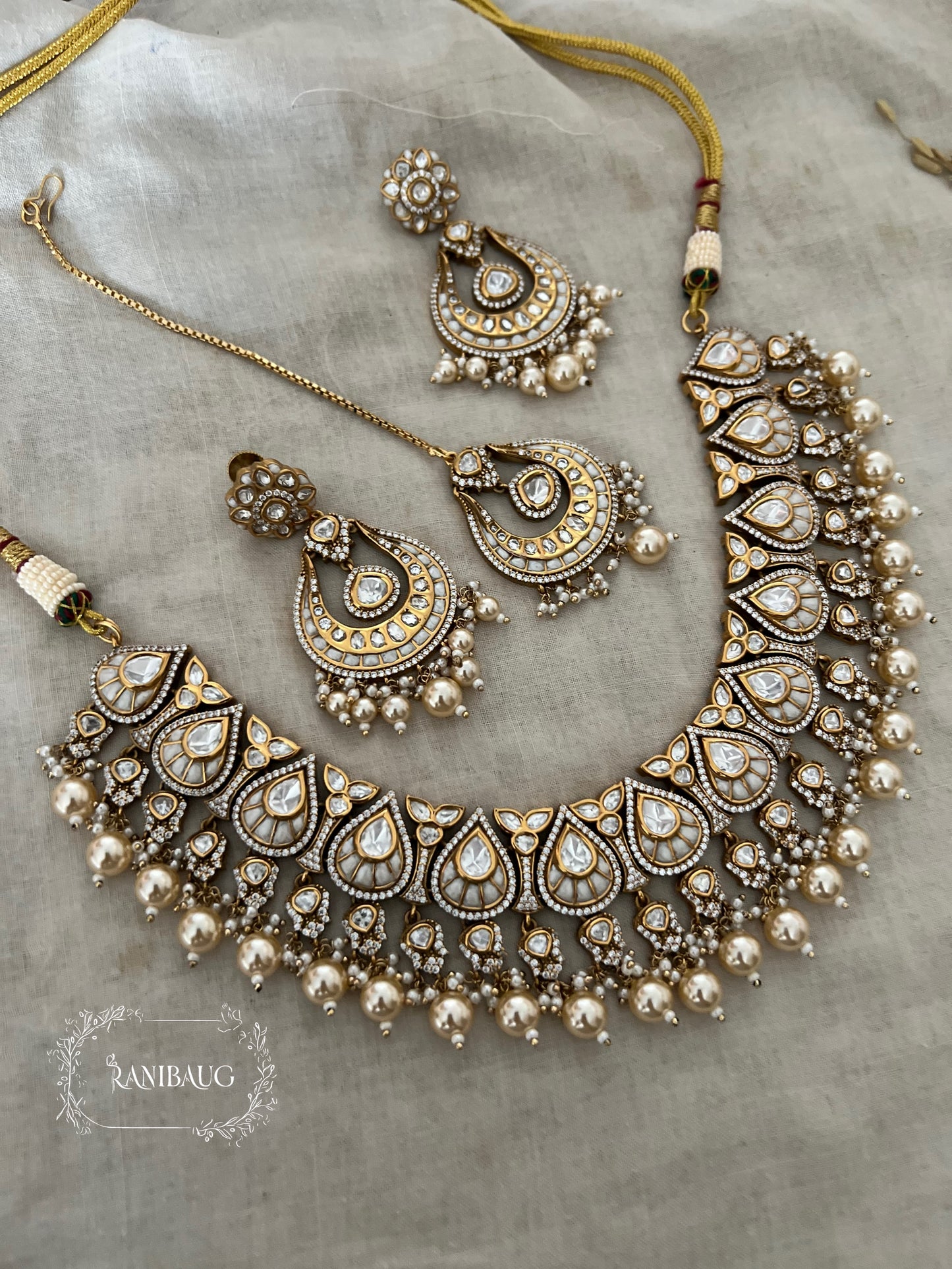 Nita Polki Kundan Necklace Set In Teardrop Enamel Motifs And Shiny Pearl Fringes In Premium Gold Finish With Contrasting Maangtikka By Ranibaug