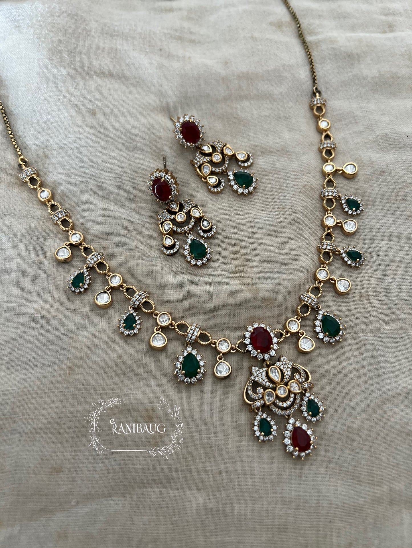 Pritisha Gold Finish Polki Ruby And Emerald Multi Color Drop Motif Designer Necklace Set By Ranibaug