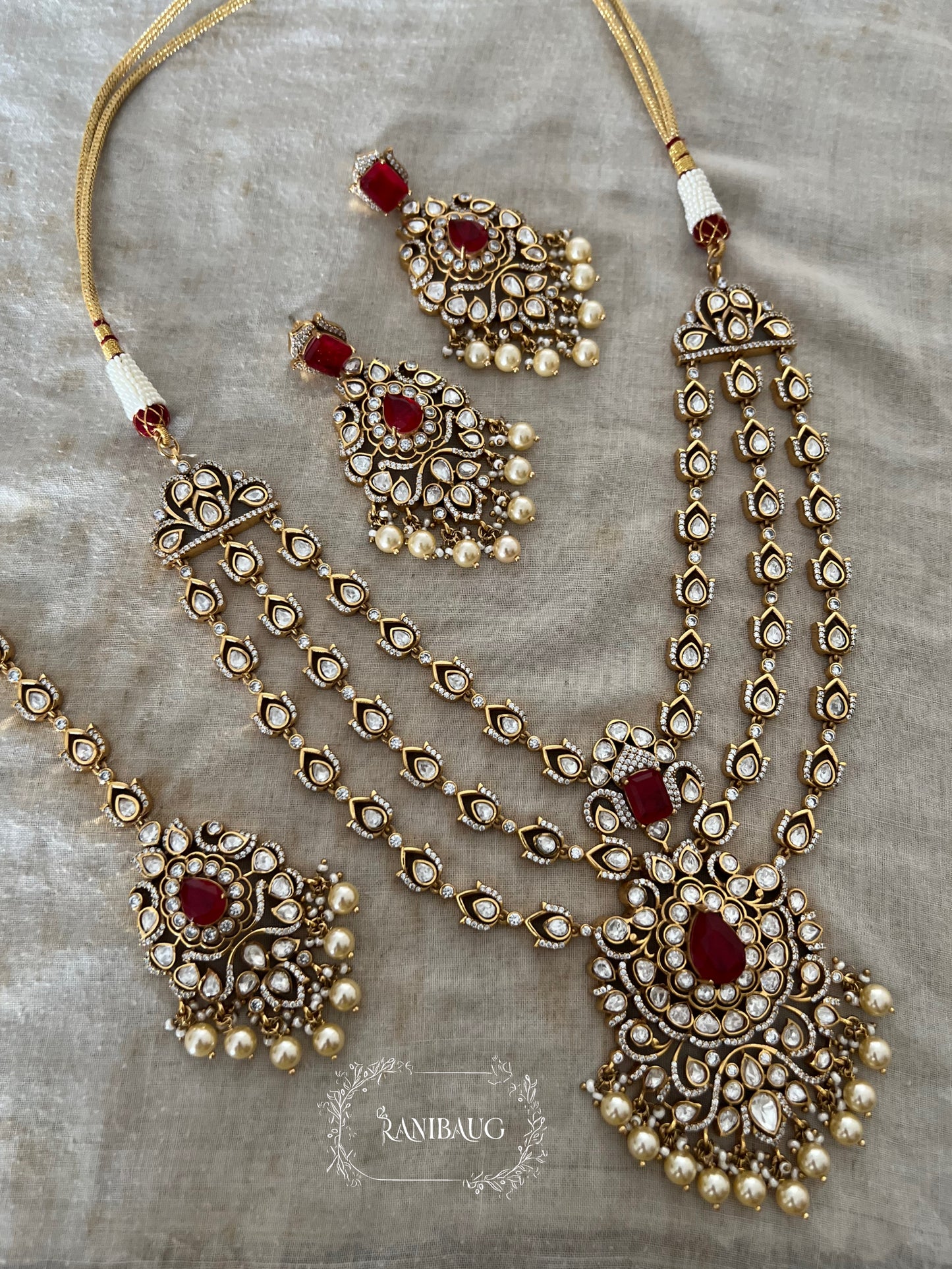 Rajeshwari Cascade Layered Gold Finish Polki Pearl Adorned Haar With Maang Tikka Necklace Set By Ranibaug
