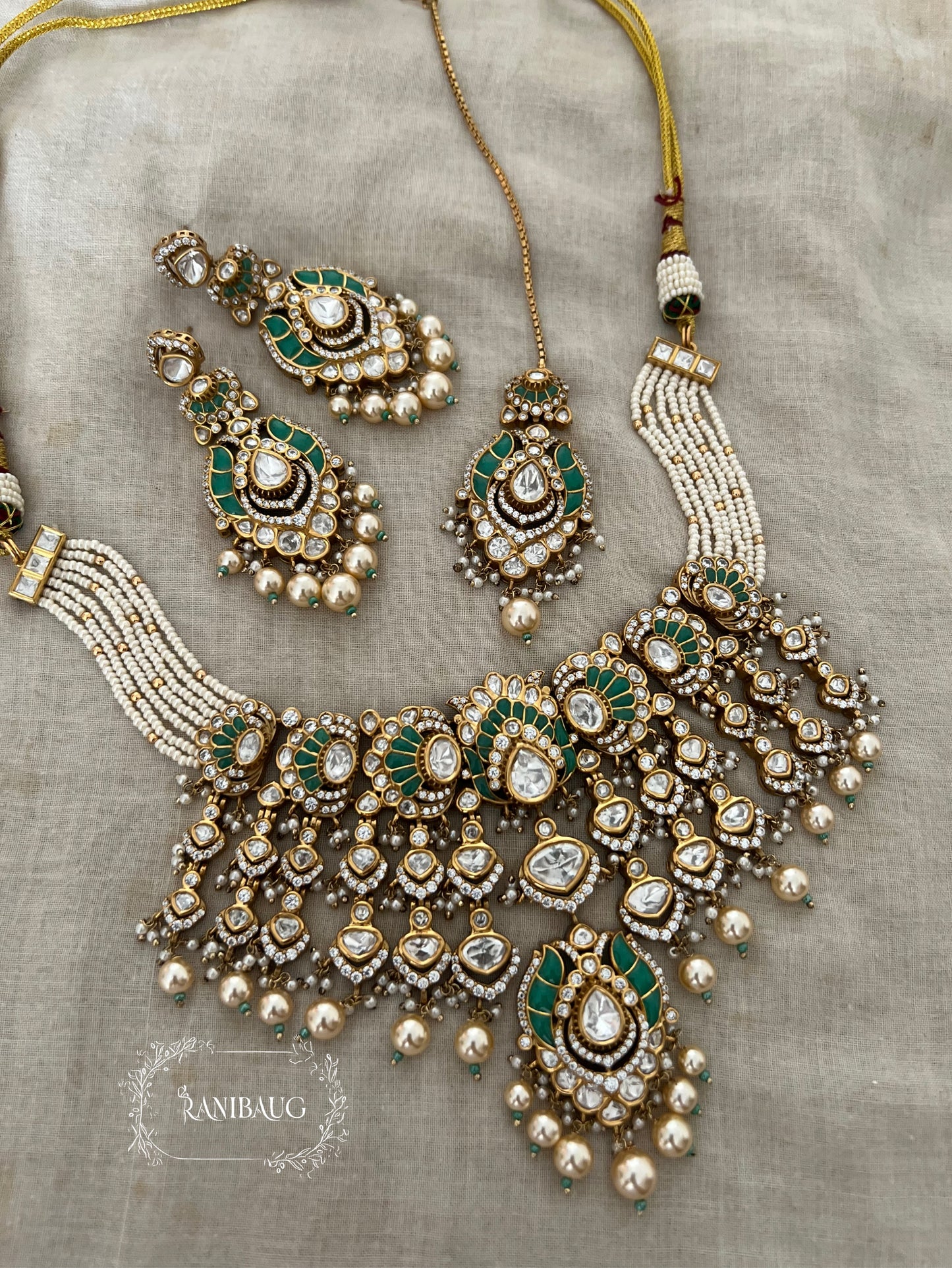 Rajnisha Polki Studded Zirconia And Pearl Adorned Enamel Gold Finish Necklace Jewelry Set With Maang Tikka By Ranibaug