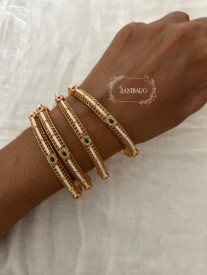 Riddhima Pearl Beaded Intricate Designer Ruby Emerald Motif Gold Heritage Bangles By Ranibaug (set of 2)