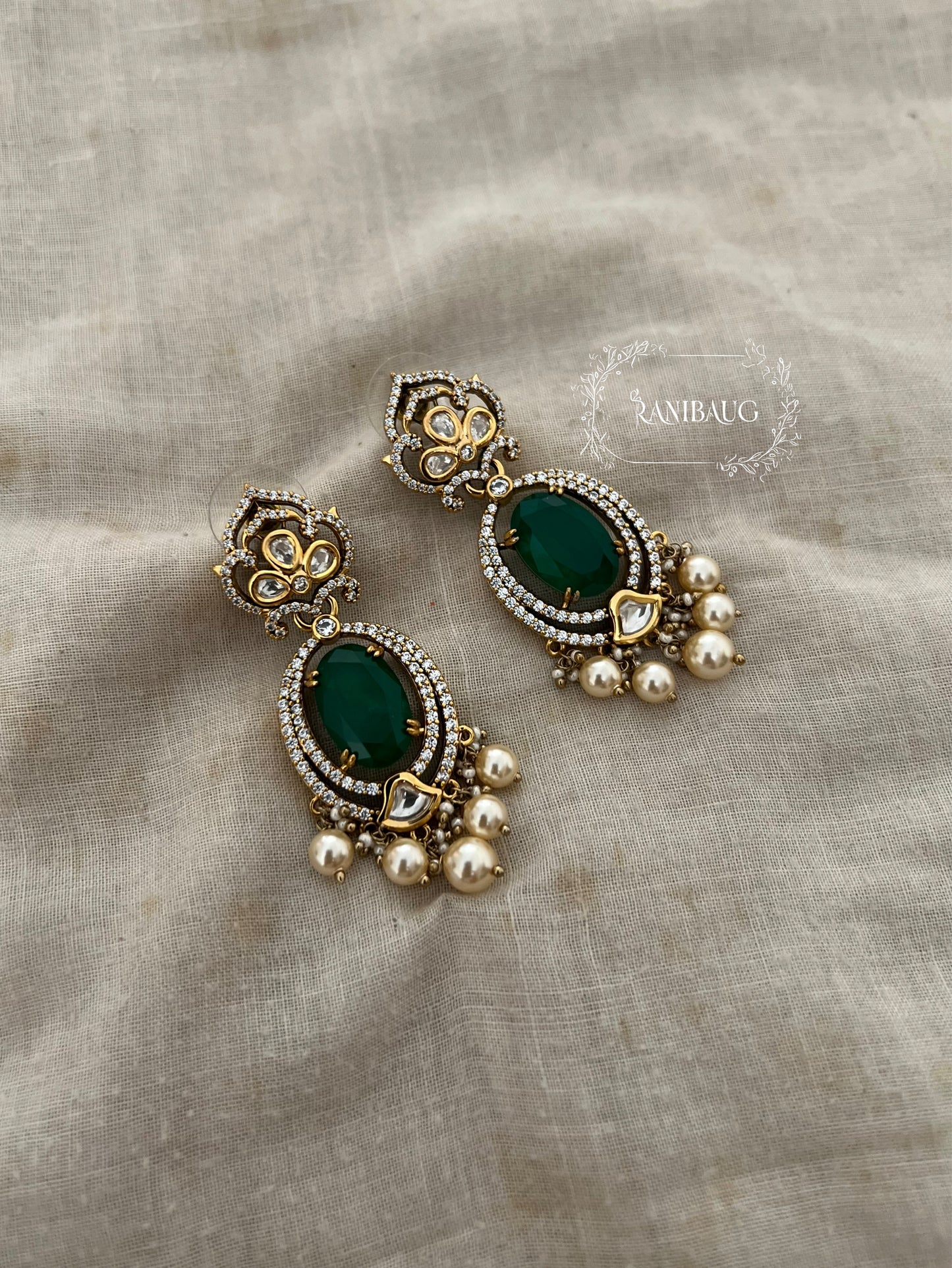 Rishiti Leaf Stud Motif Emerald Green Stone And Pearl Festive Earrings By Ranibaug