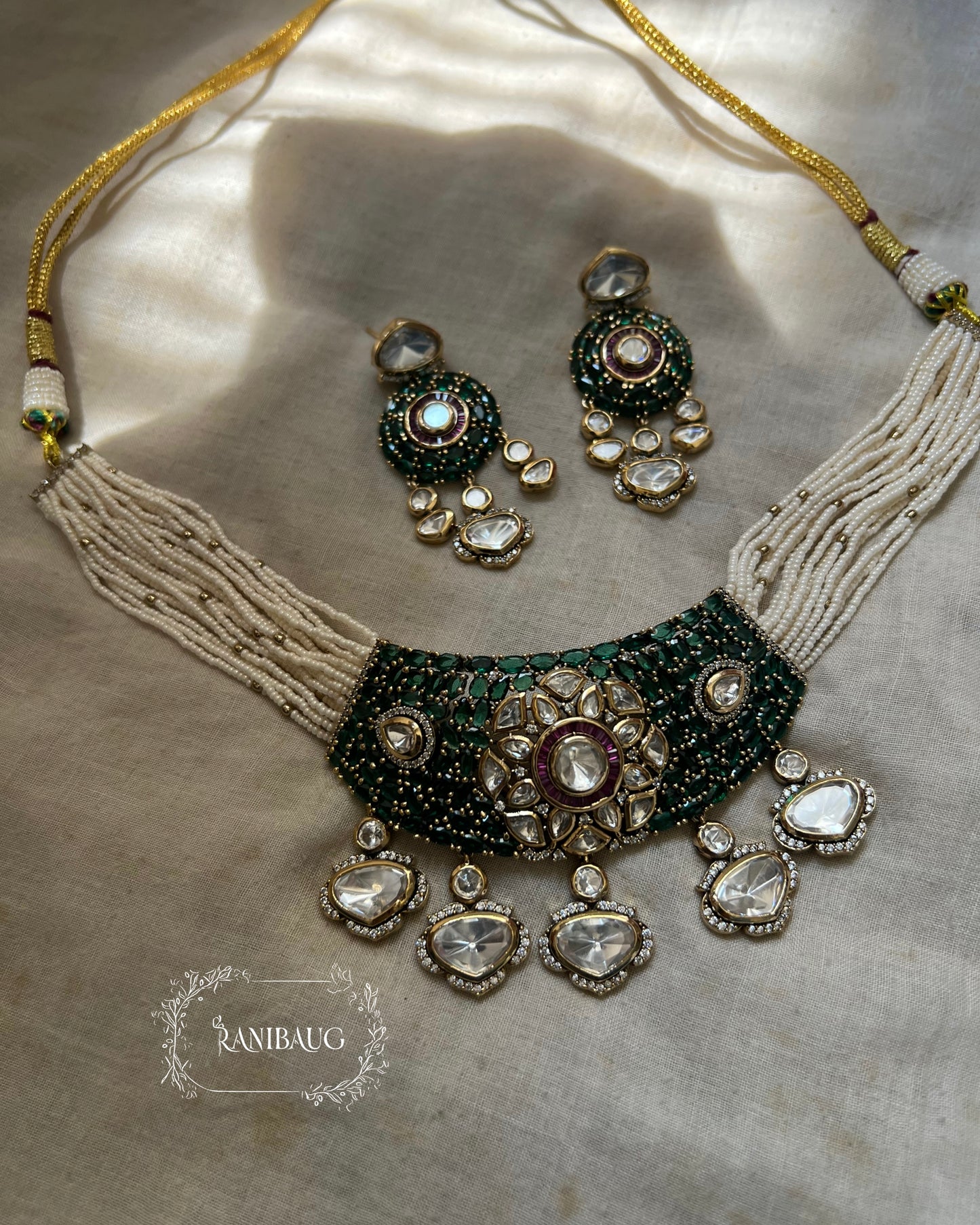 Riva Emerald Stone Polki Floral Motif Kundan Drop Gold Plated Pearl Strand Choker Necklace Set By Ranibaug