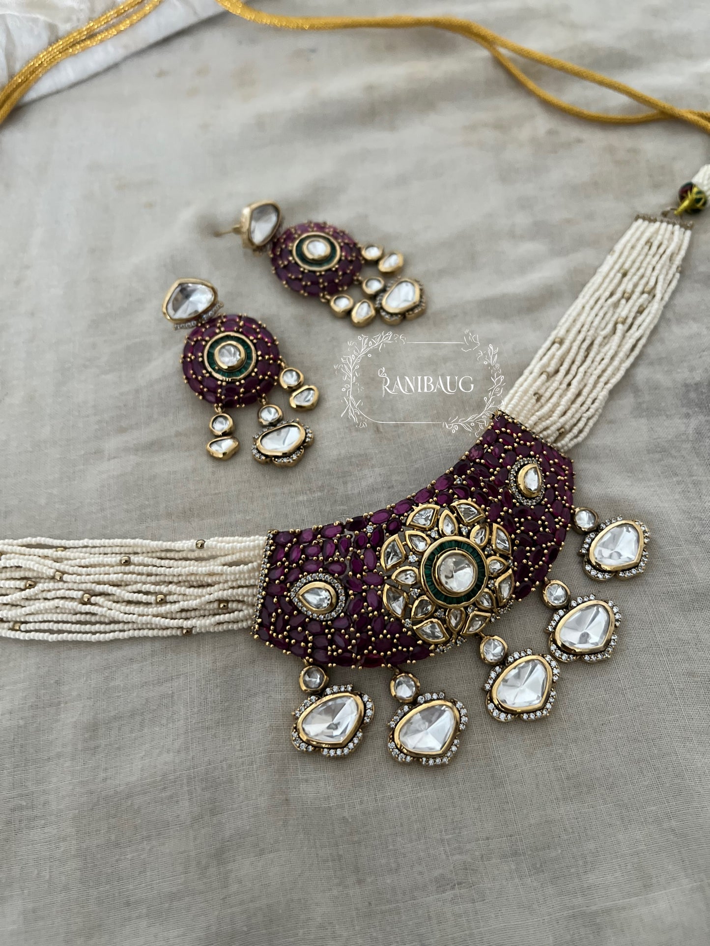 Riva Emerald Stone Polki Floral Motif Kundan Drop Gold Plated Pearl Strand Choker Necklace Set By Ranibaug