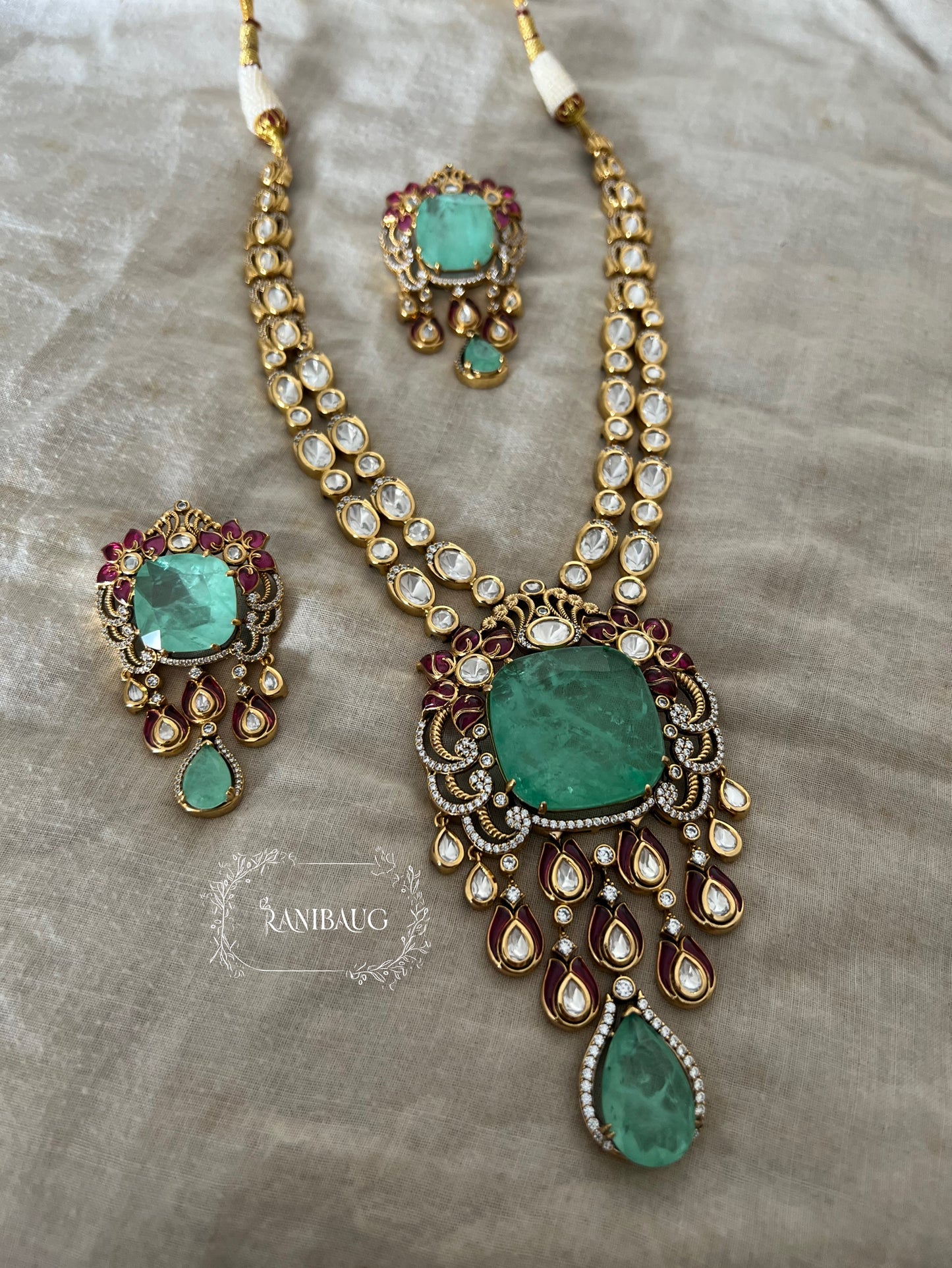 Shreya Bold Long Adjustable Green Emerald And Kundan Necklace Set In Rich Gold Finish By Ranibaug