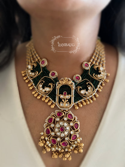 Shyama Gold Finish Peacock Motif Deep Green And Ruby Adorned Polki Heritage Jewellery Set By Ranibaug