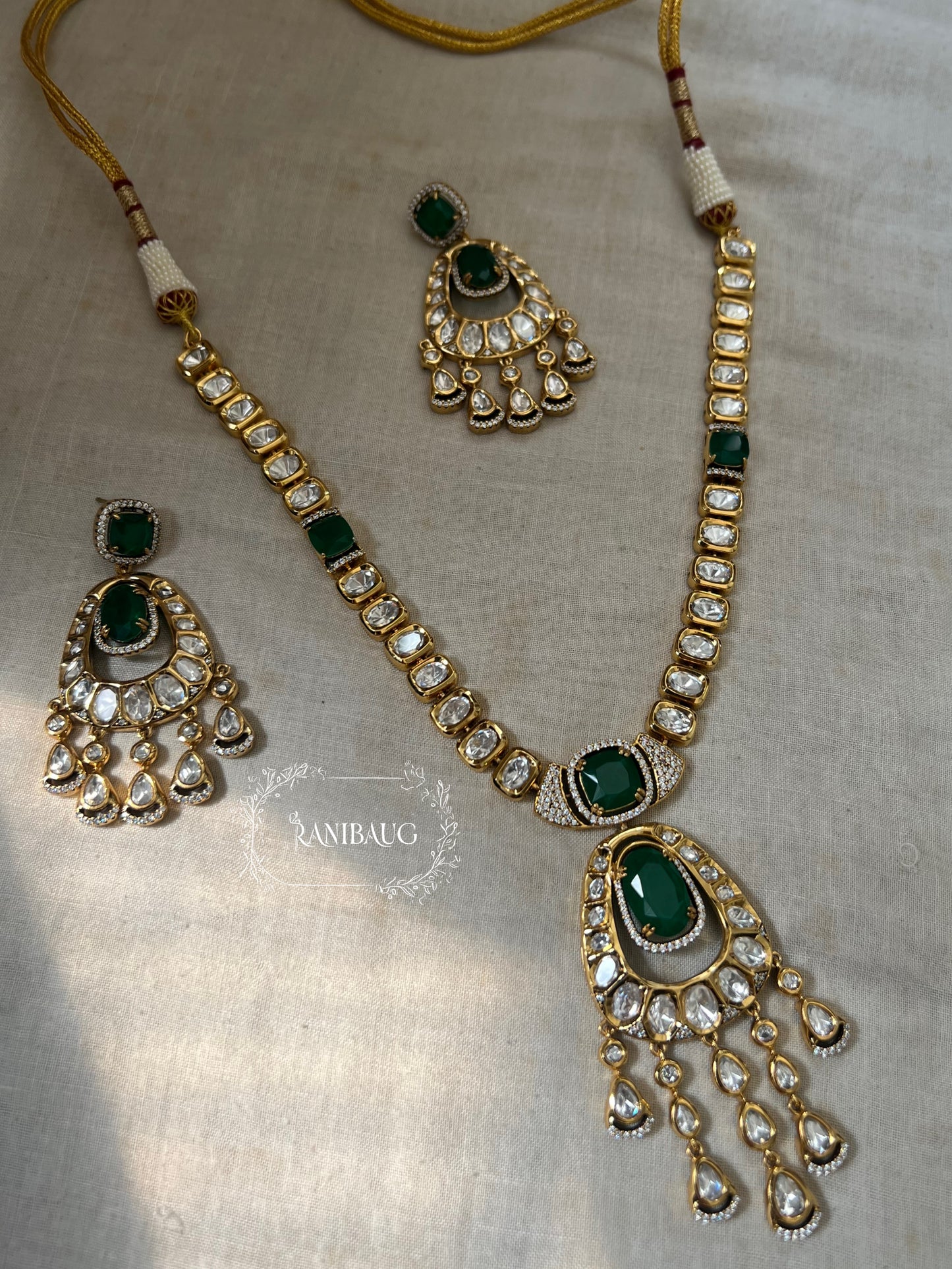 Suman Emerald Green Gemstone Teardrop Motif In Kundan Studs And Premium Gold Finish Necklace Jewellery Set By Ranibaug