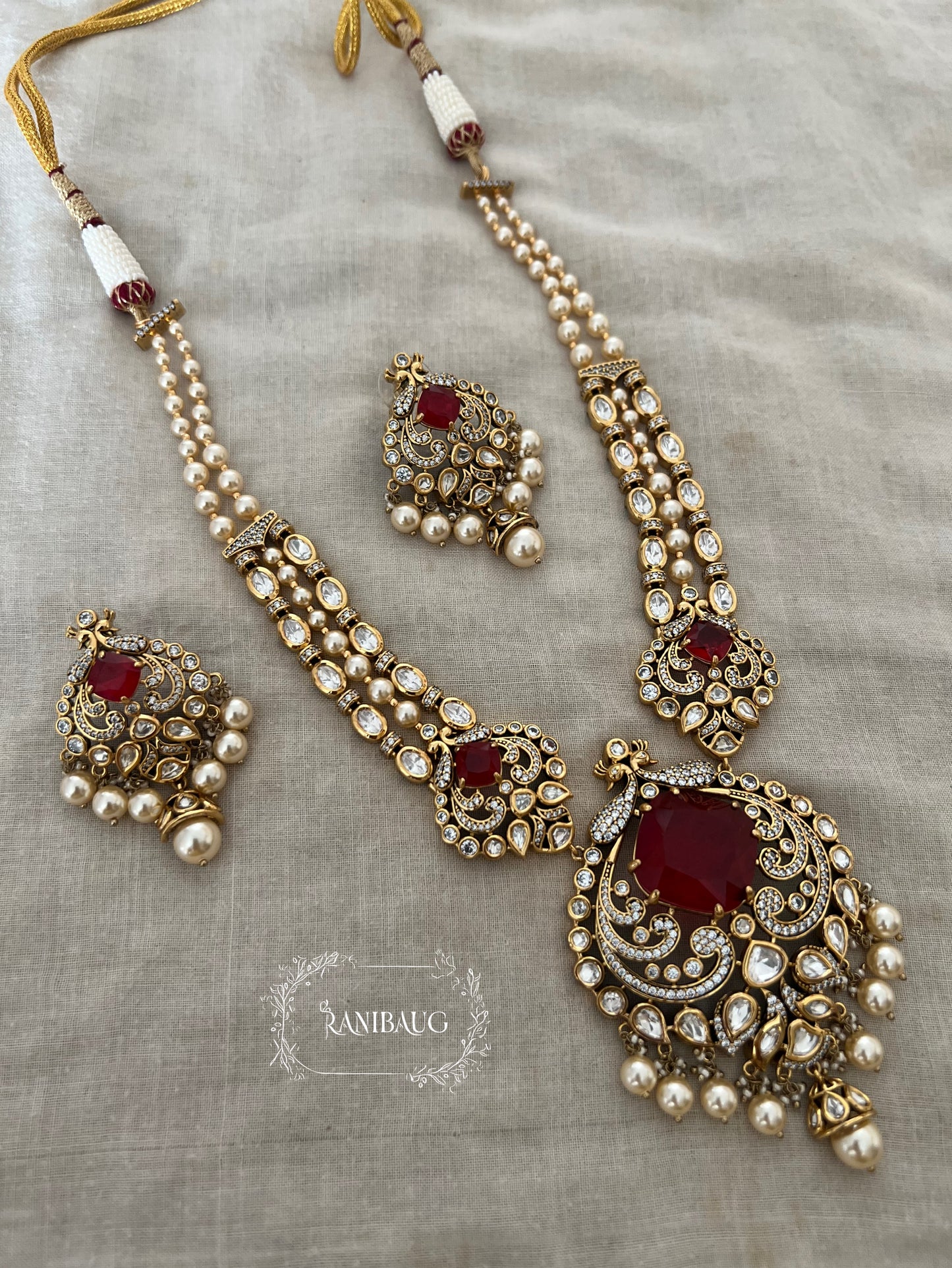 The Maharani’S Heirloom: Pearl Strand Necklace With Peacock Jadau Pendant | Emerald Green & Ruby Red Variants By Ranibaug