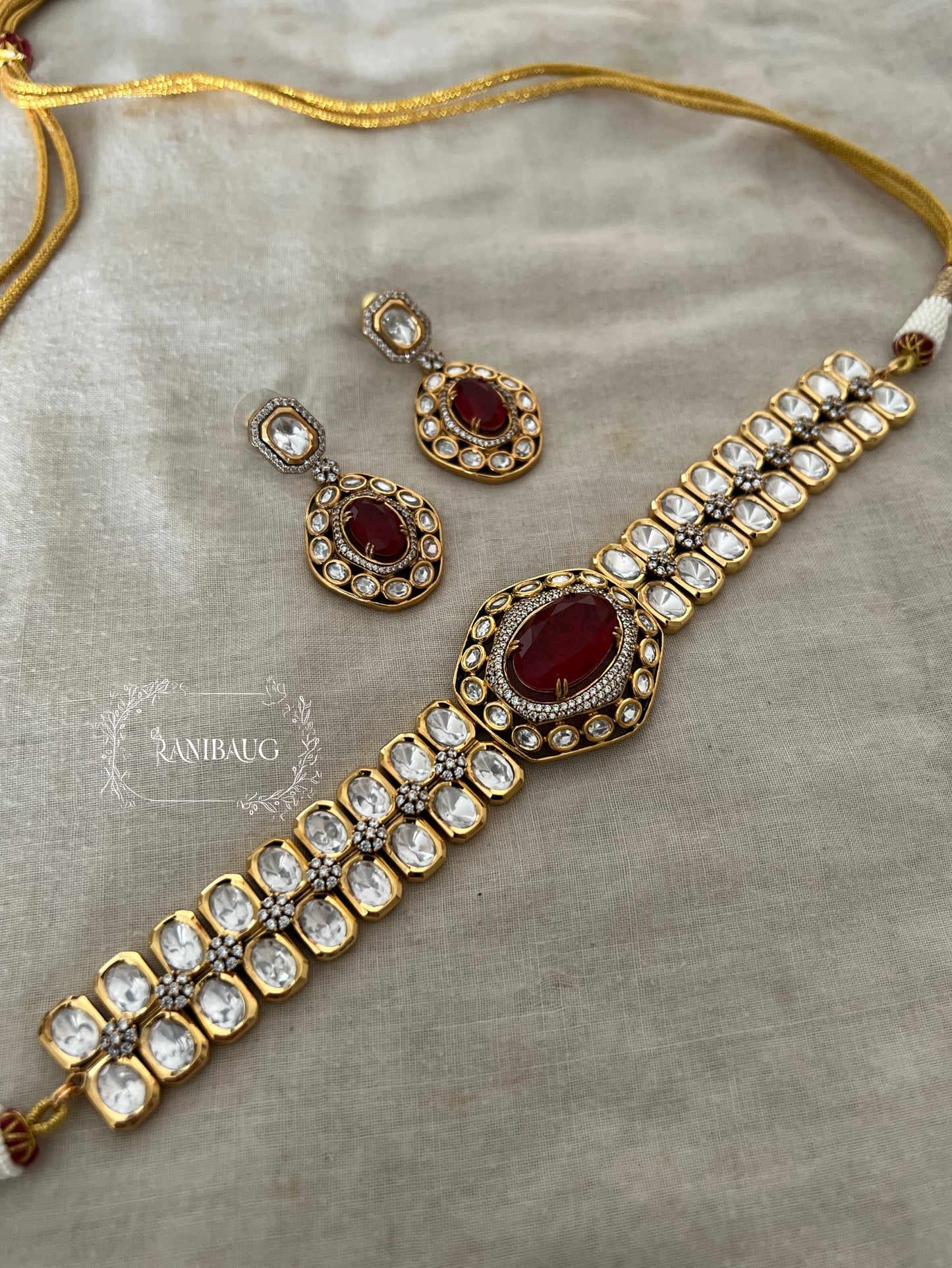 The Royal Sash Polki Choker Necklace Set | Ruby & Emerald Centerpiece In Rich Gold Finish By Ranibaug