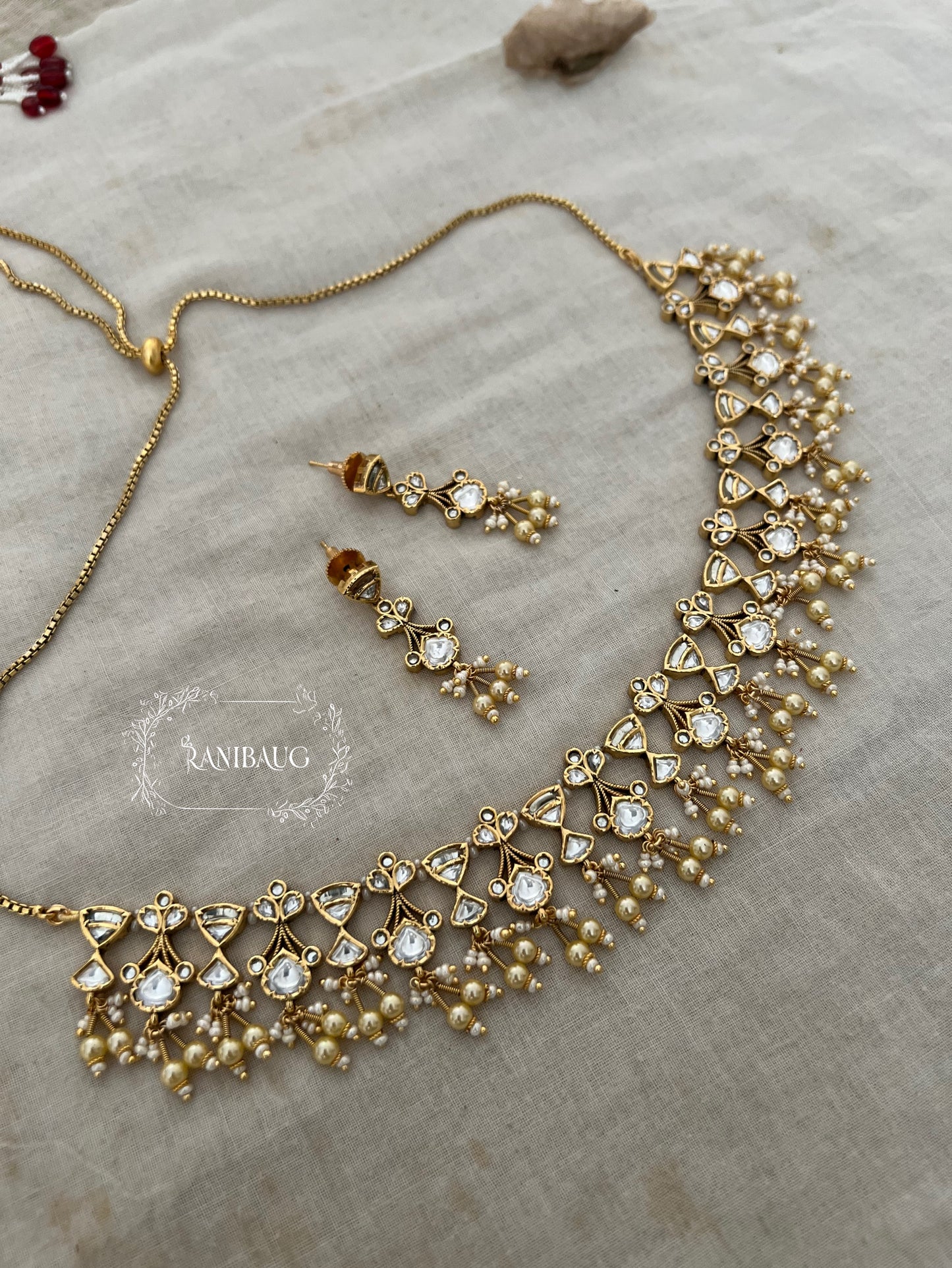 The Rukmini Rang-Mahal Polki Hourglass Necklace | Ruby & Emerald Geometric Fringe Set by Ranibaug