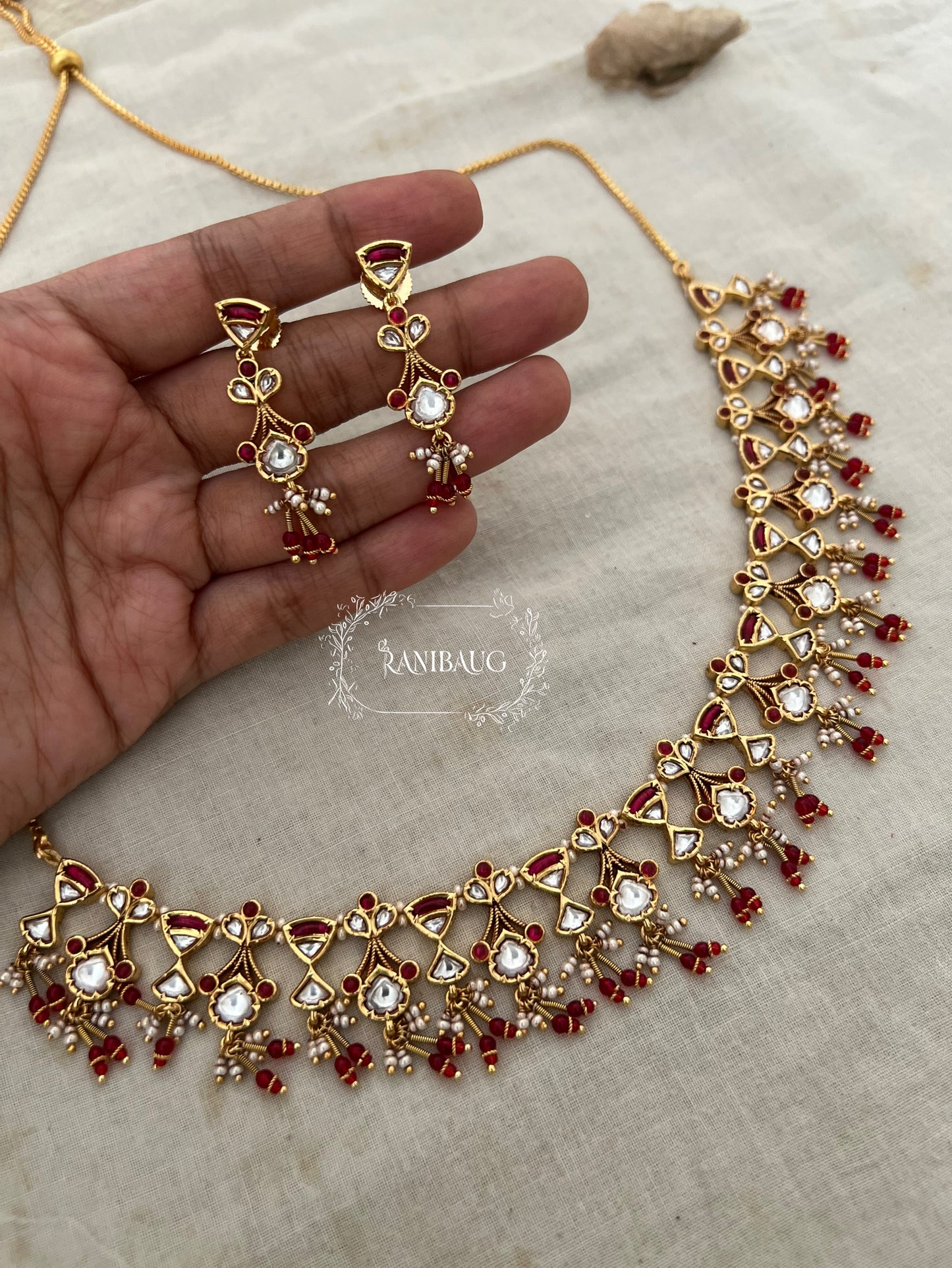 The Rukmini Rang-Mahal Polki Hourglass Necklace | Ruby & Emerald Geometric Fringe Set by Ranibaug