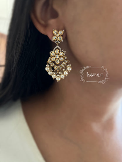 Vanika Gold Finish Polki Studded Pearl Adorned Dangling Floral Motif Earrings