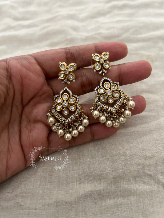 Vanika Gold Finish Polki Studded Pearl Adorned Dangling Floral Motif Earrings