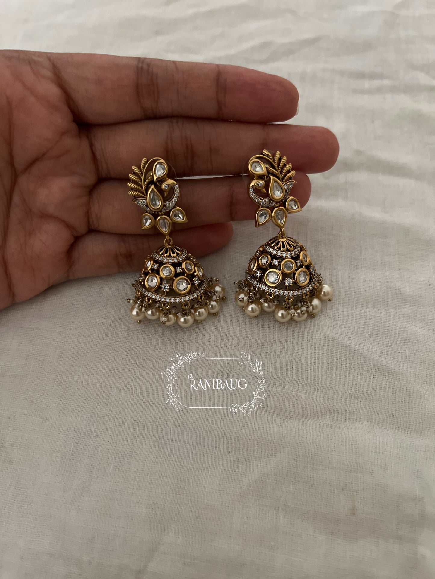 Vanika Polki Peacock Gold Finish Pearl Adorned Designer Jhumka Earrings By Ranibaug