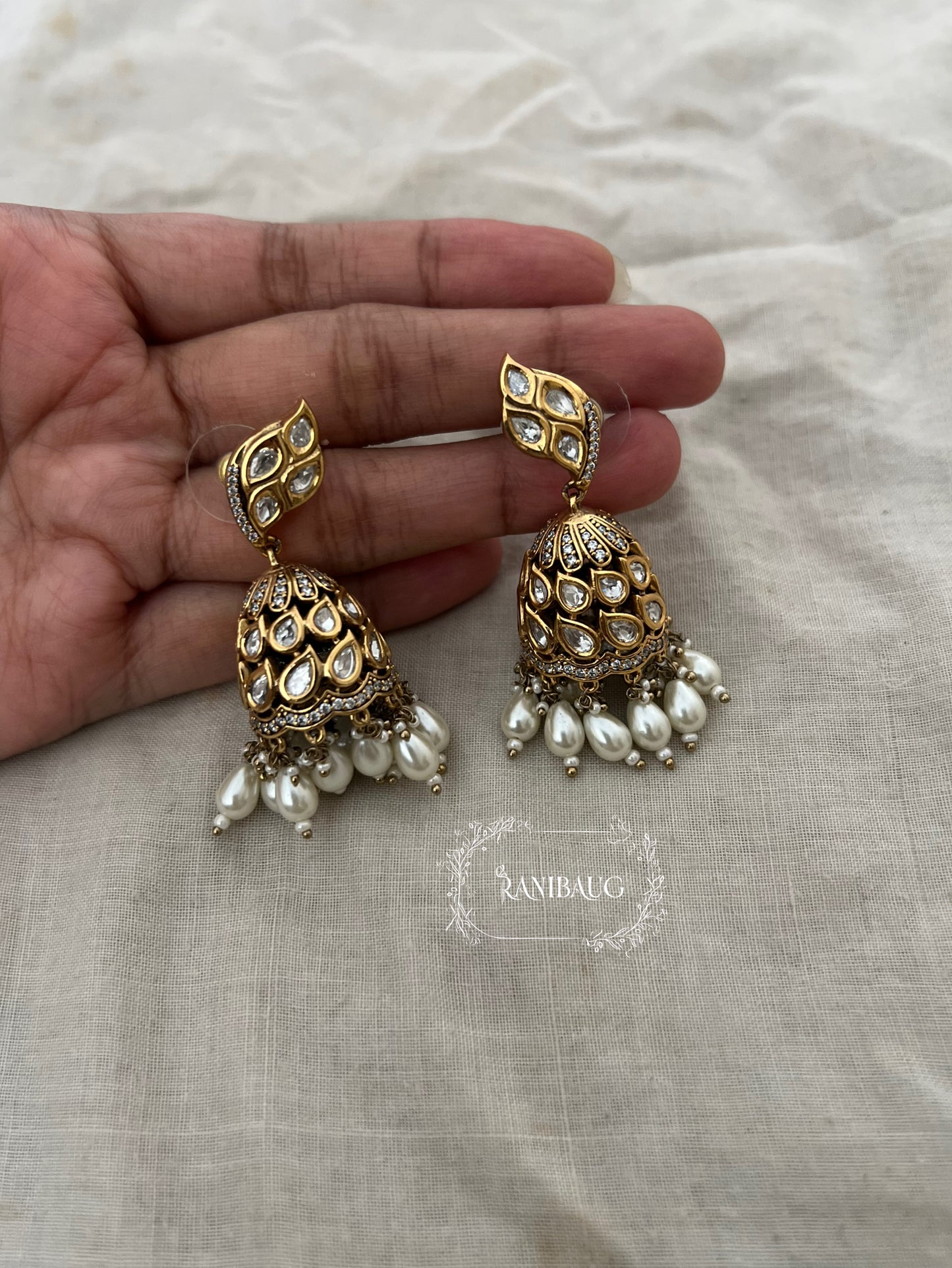 Varshini Premium Gold Finish Polki Adorned Sway Style Jhumka With Pearls By Ranibaug