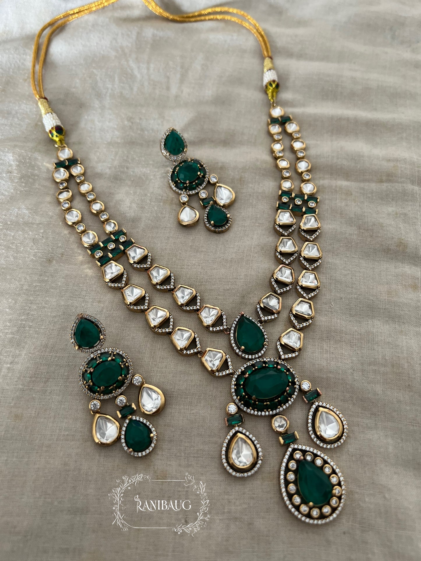 Zarika Geometric Polki Studded Gold Finish Emerald Stones Adorned Two Layered Necklace Set By Ranibaug