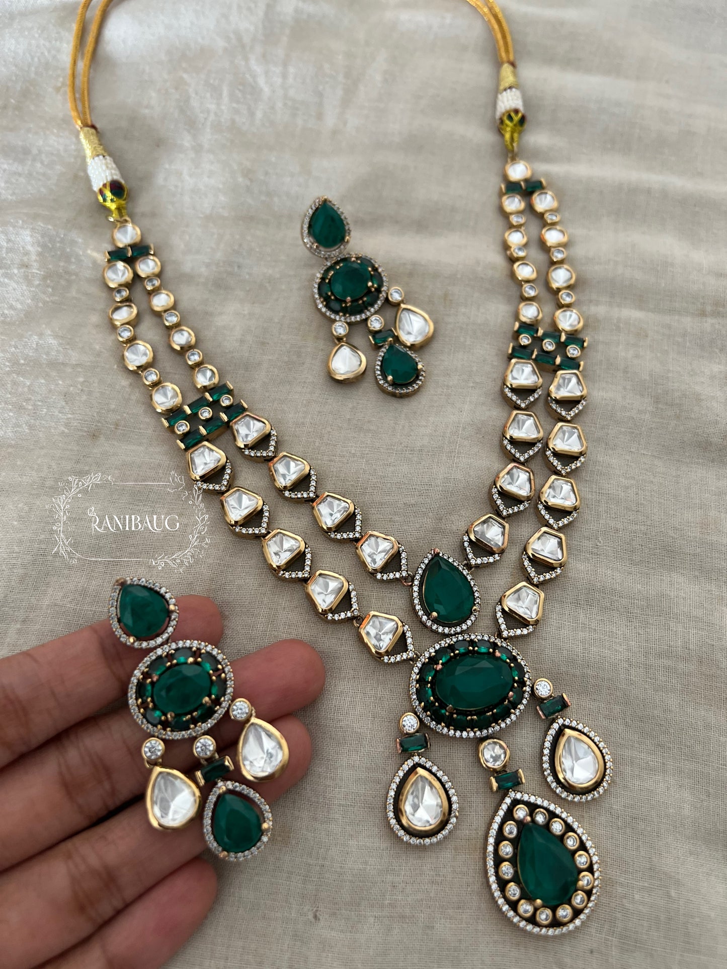 Zarika Geometric Polki Studded Gold Finish Emerald Stones Adorned Two Layered Necklace Set By Ranibaug